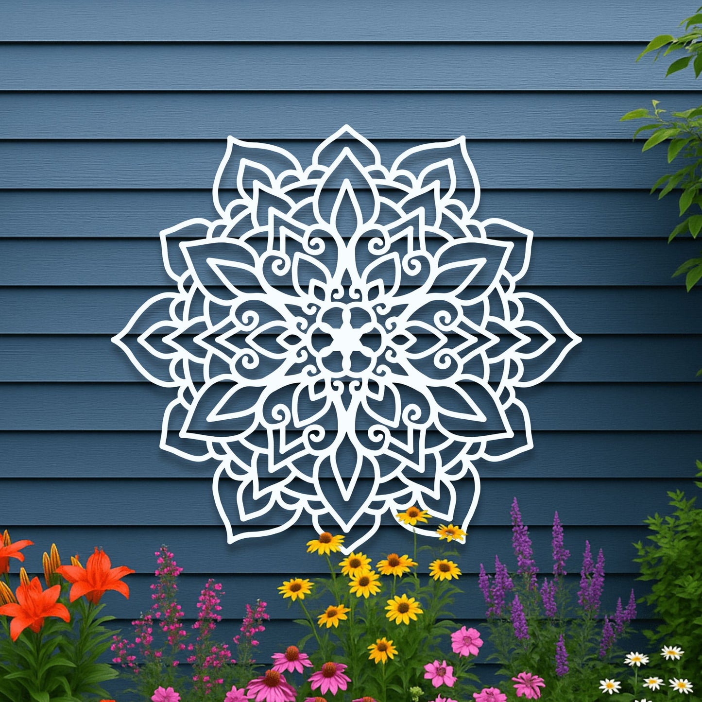 White floral mandala design on a blue wooden wall with colorful flowers below.