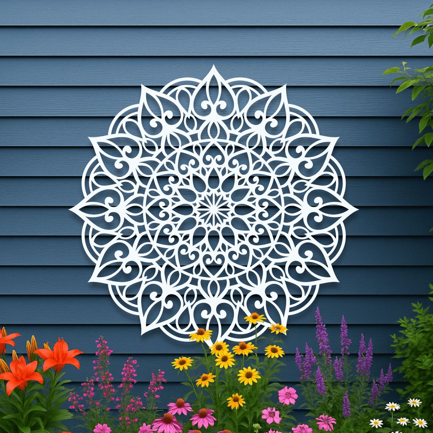 Decorative white mandala wall art on a blue wooden panel background with flowers in the foreground.