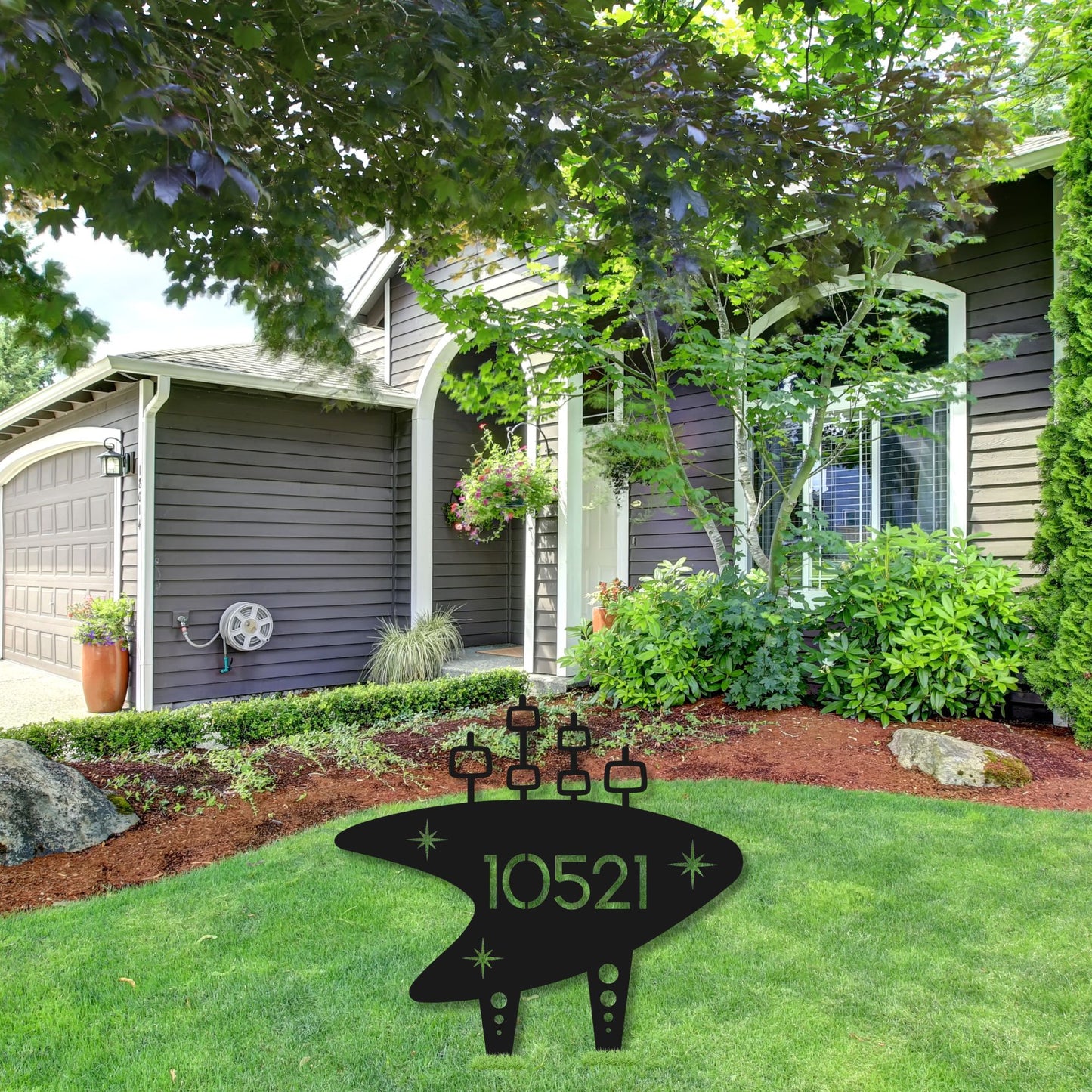 House exterior with a decorative address sign in a garden setting