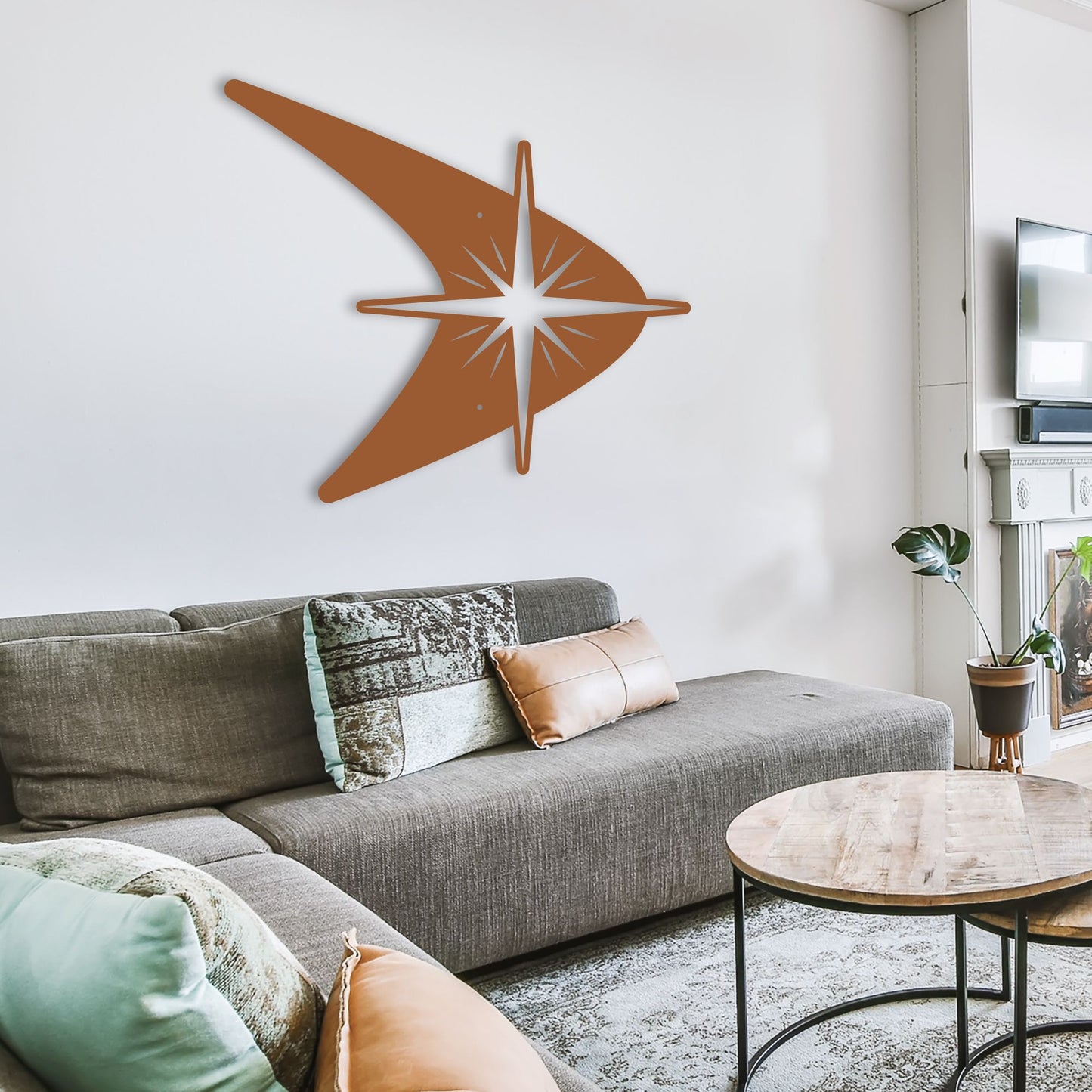 Living room with a gray sectional sofa, decorative pillows, and a wall art piece.