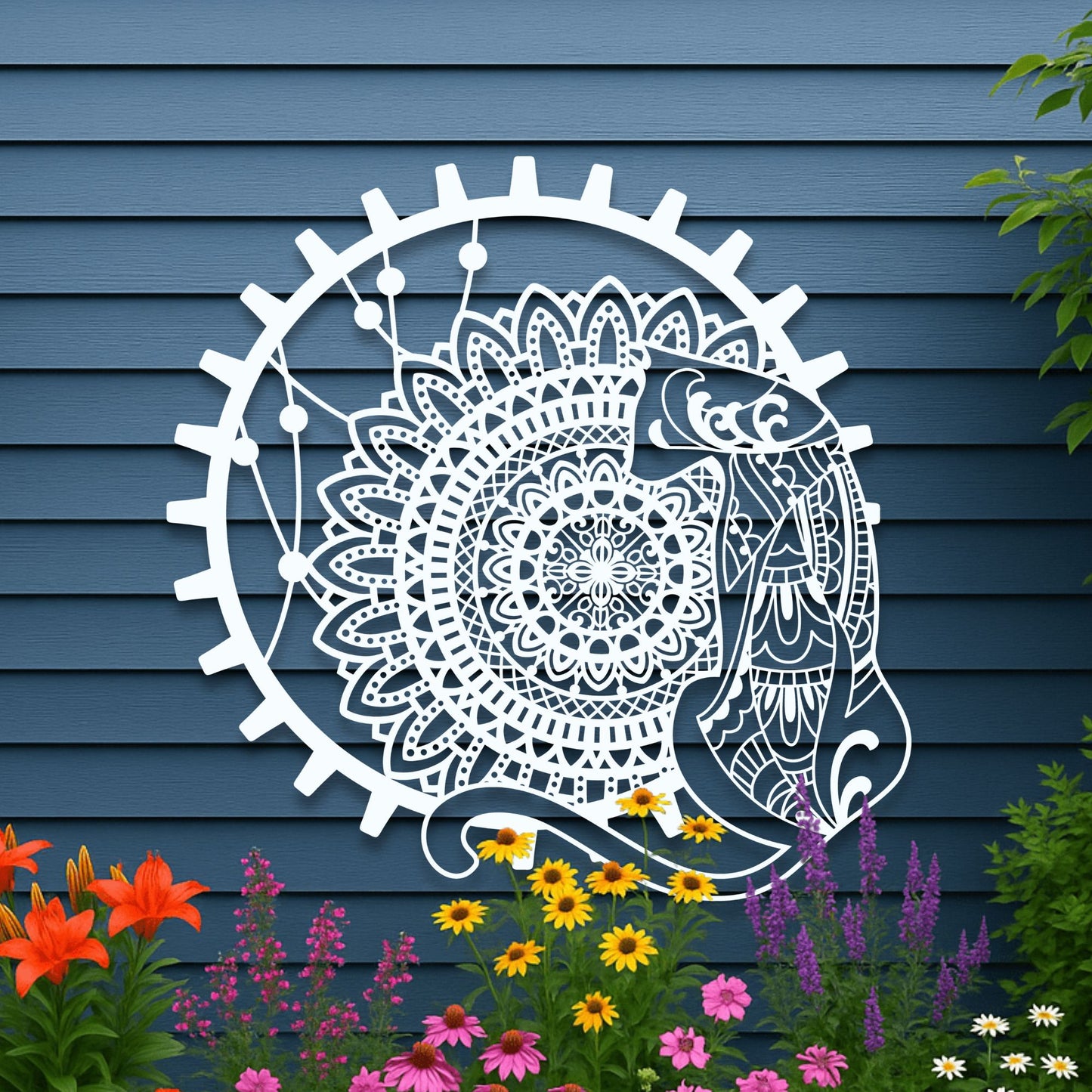 Decorative wall art of a fish and mandala design on a blue wooden wall with flowers in the foreground.