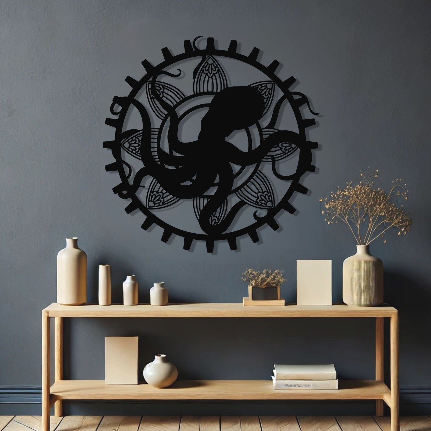 Decorative wall art of a snake in a circular design on a dark gray wall above a wooden console table.