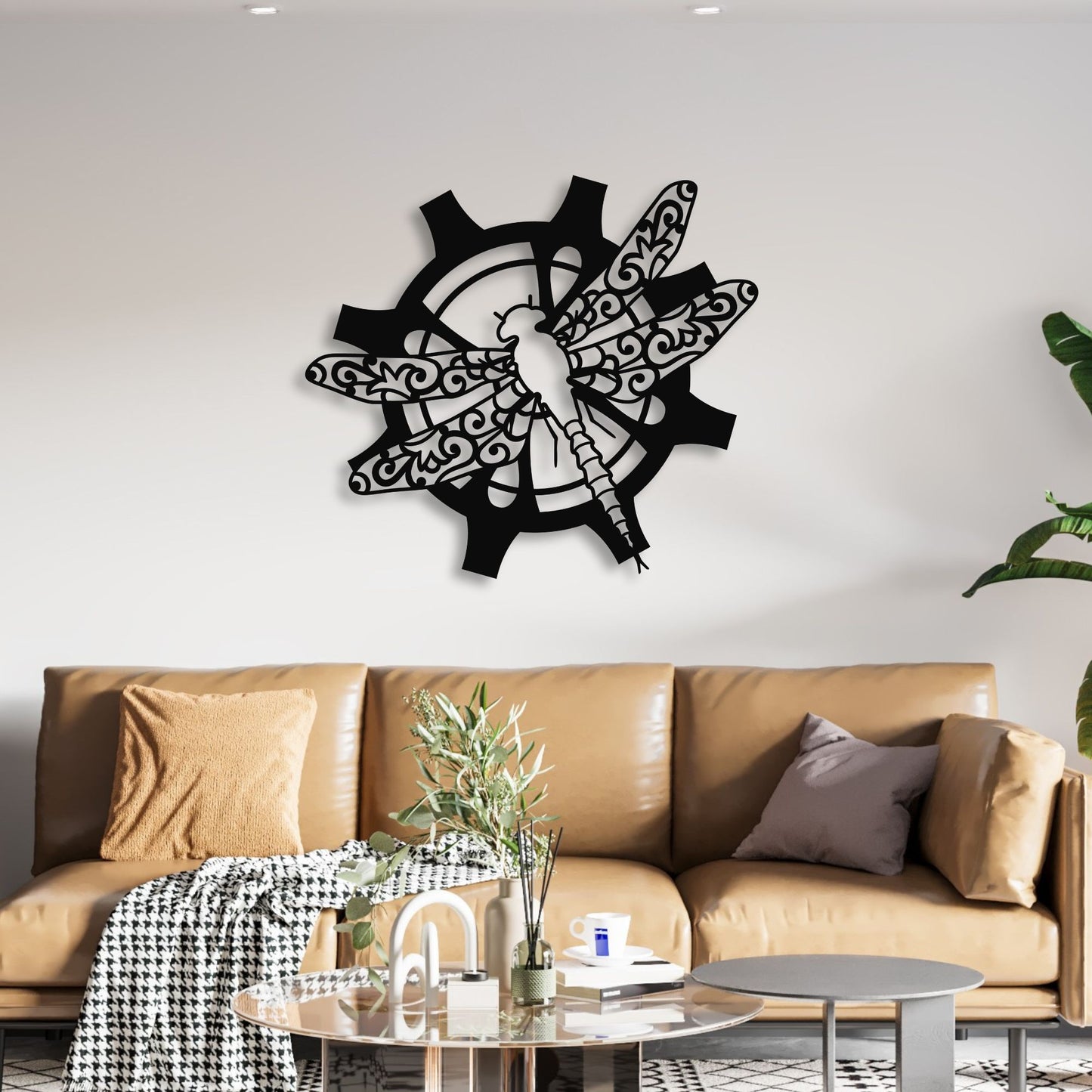 Dragonfly wall clock on a white wall above a brown sofa with decorative items.