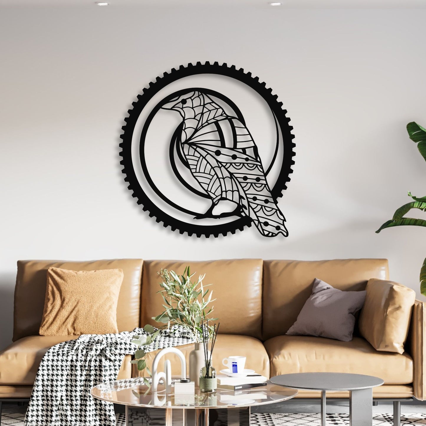 Decorative wall art with a black and white design on a white wall above a brown sofa.