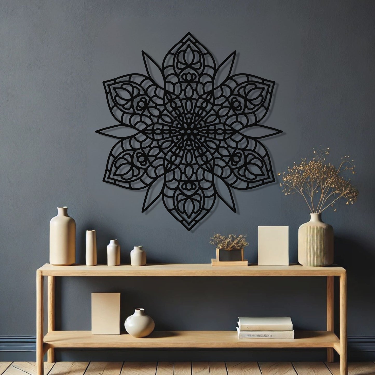 Decorative black mandala wall art on a dark gray wall with a wooden console table and decorative items.