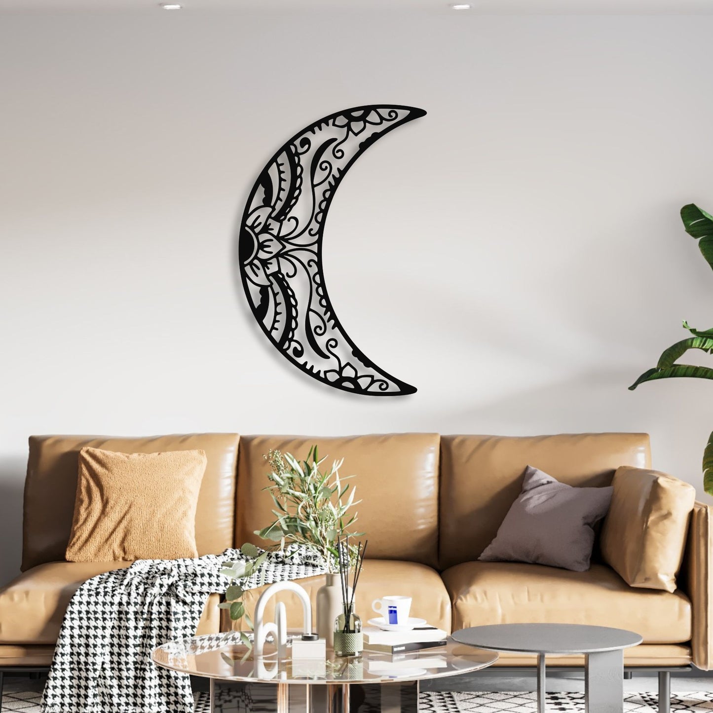 Decorative metal crescent moon wall art above a brown sofa in a living room.