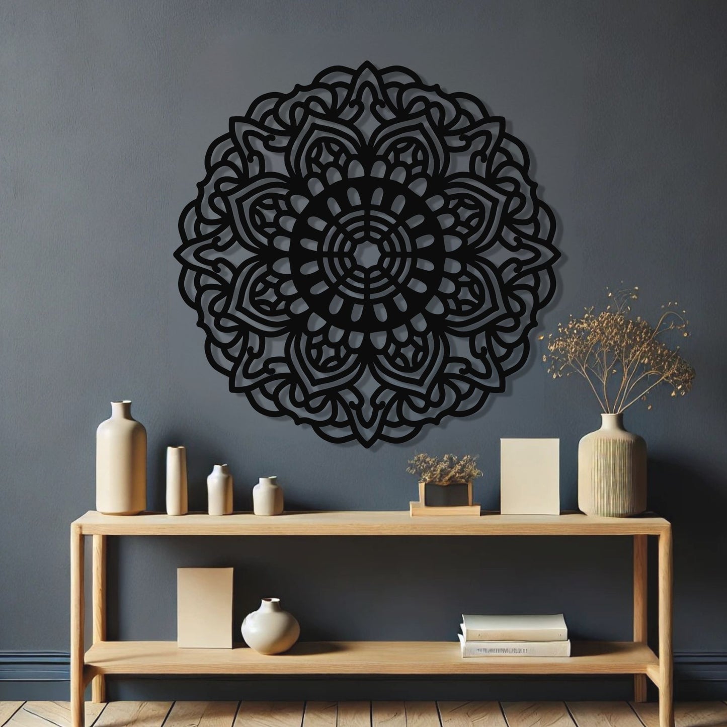 Decorative black mandala wall art on a gray wall with a wooden console table below.