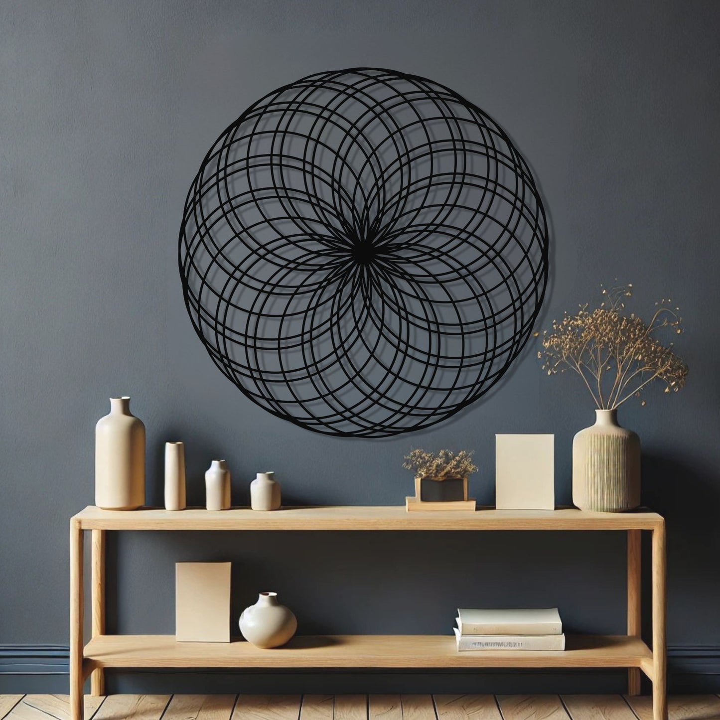 Decorative black circular wall art above a wooden console table with various decor items.