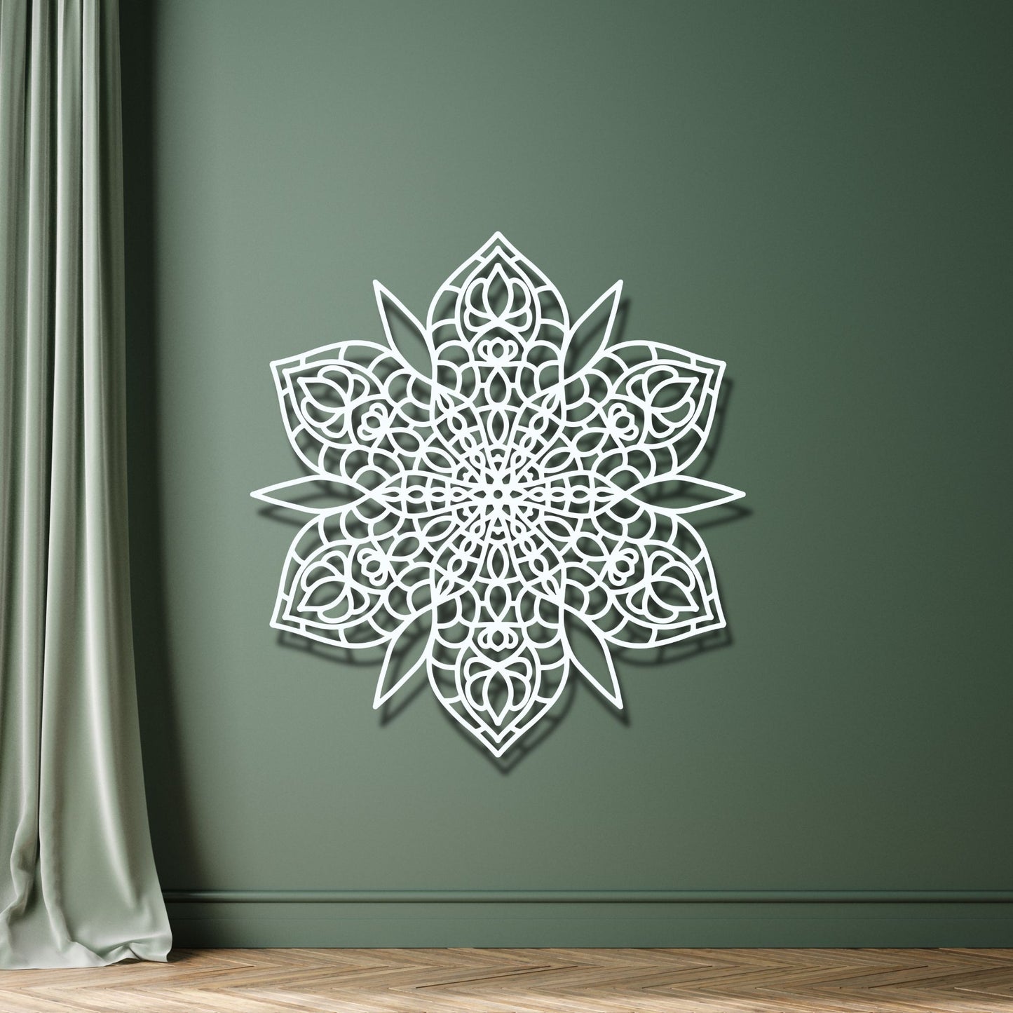 Decorative white wall art on a green wall with a curtain and wooden floor.