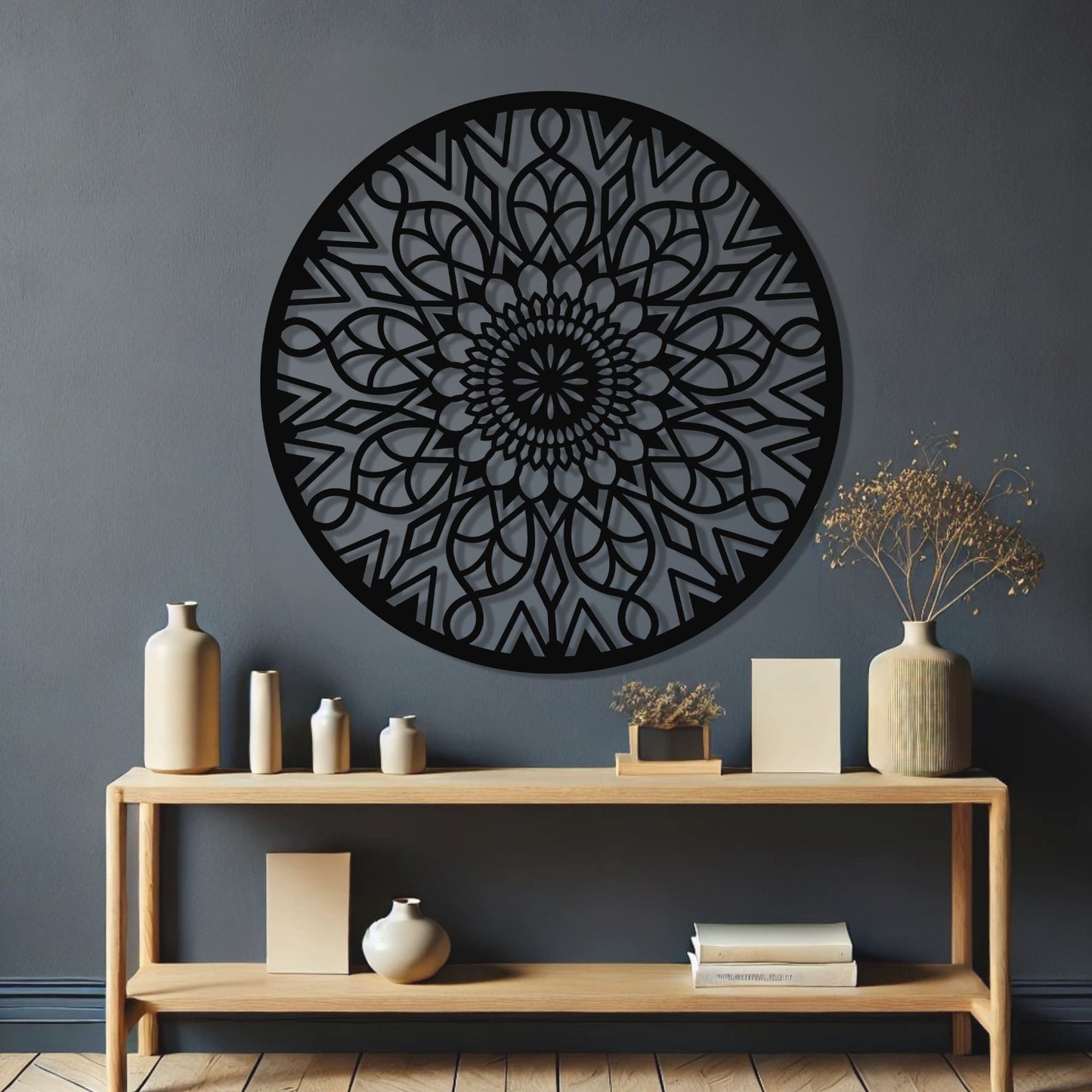 Decorative wall art with a black geometric pattern on a gray wall above a wooden console table.