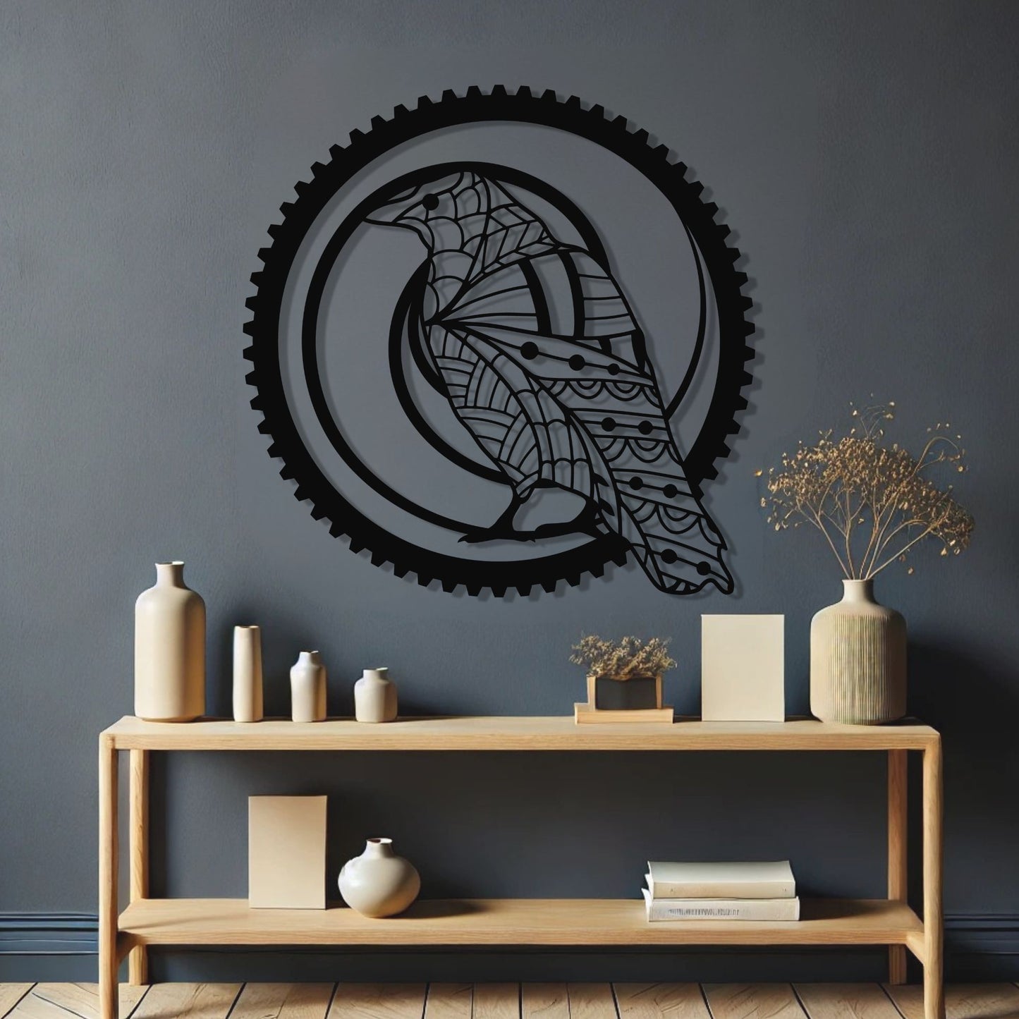 Decorative wall art with a gear design on a dark gray wall above a wooden console table.