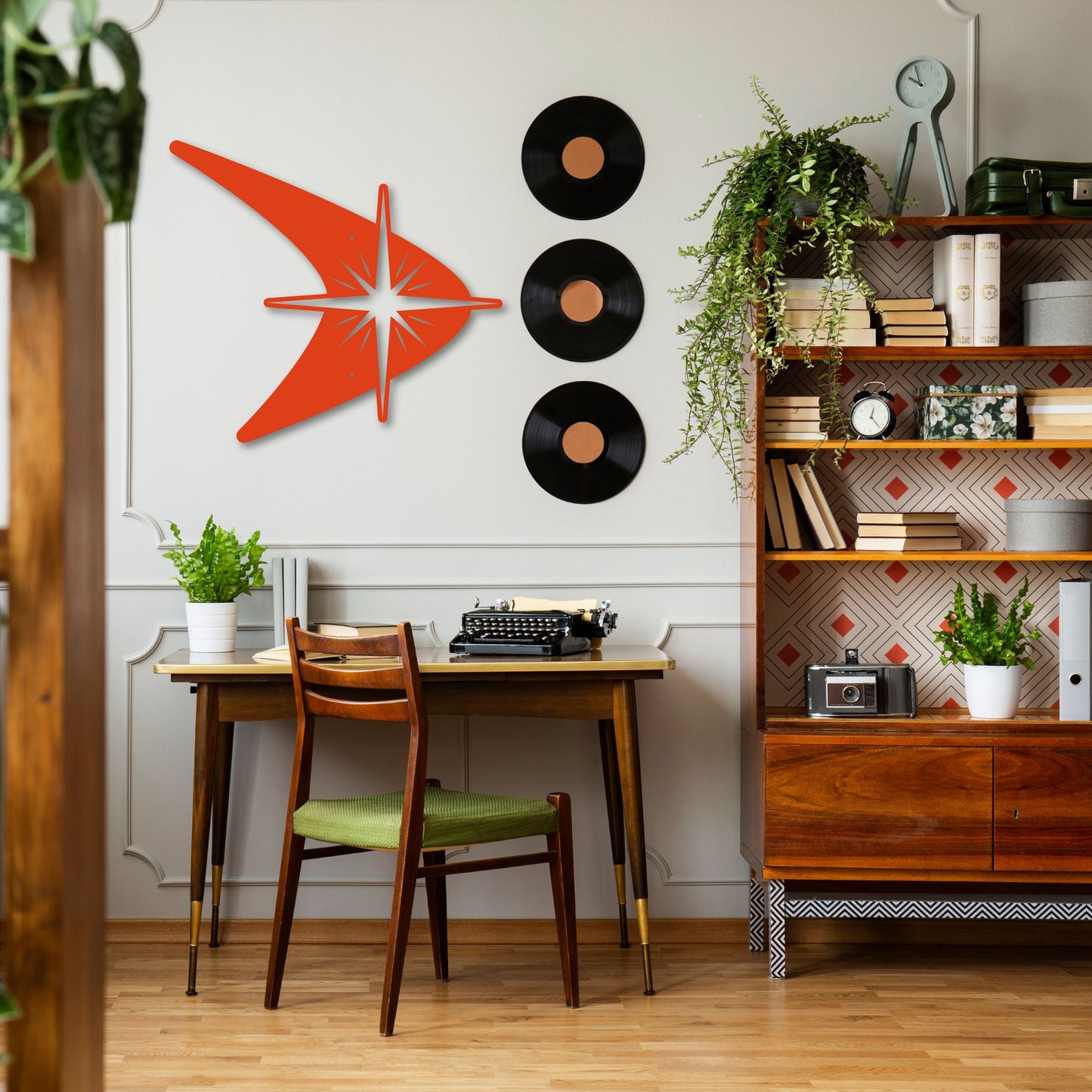 Modern home office with a desk, chair, and decorative wall art.