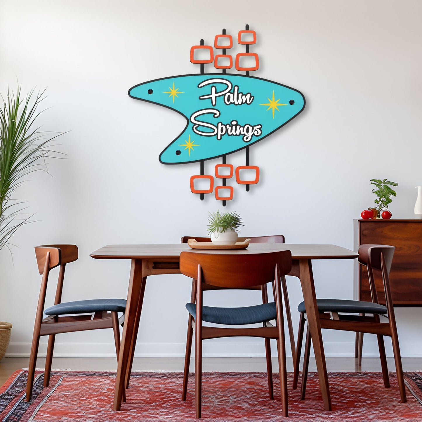 Dining room with a 'Palm Springs' wall art above a wooden table and chairs.
