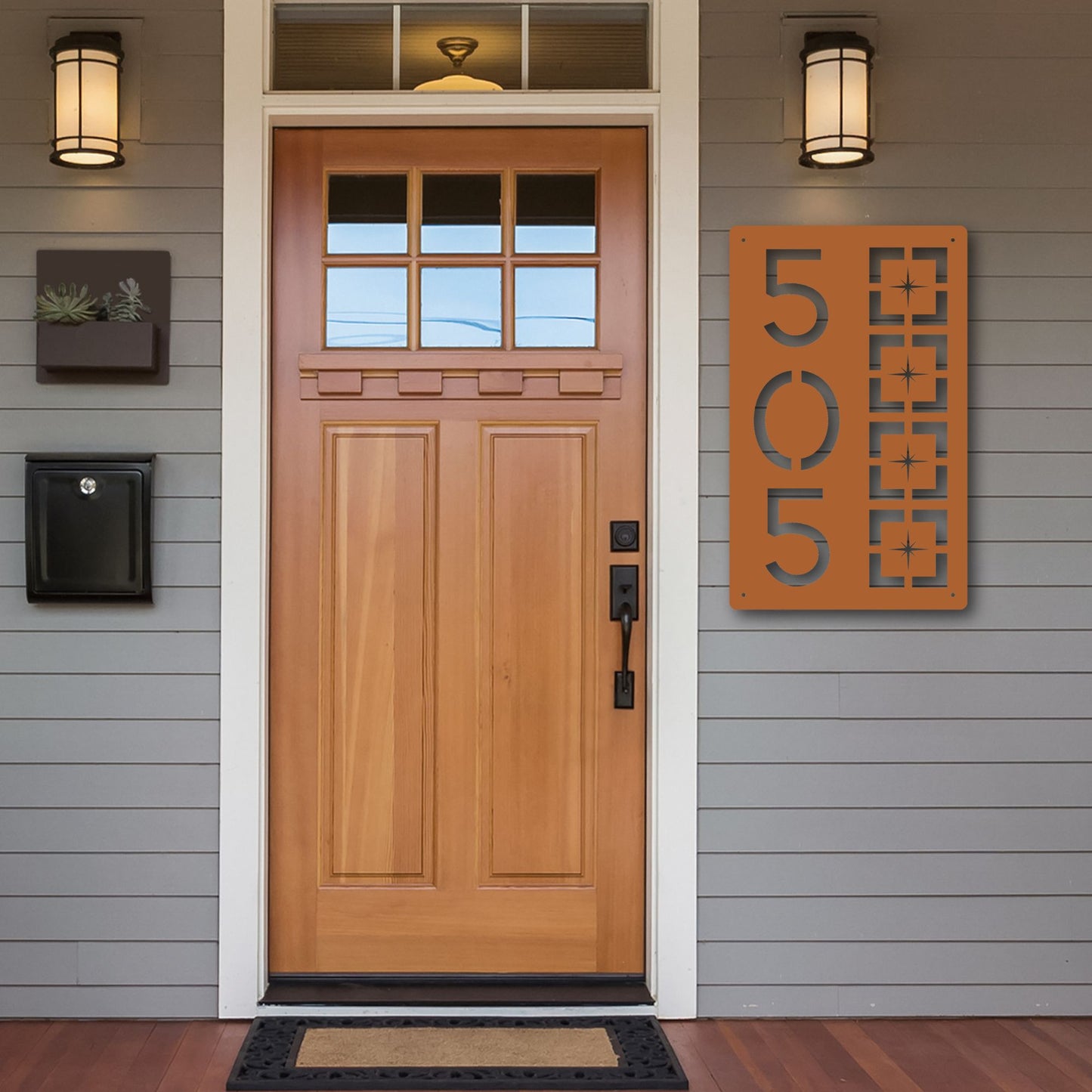 Metal Address Sign, Vertical Starburst Block shown in copper on warm cedar front porch