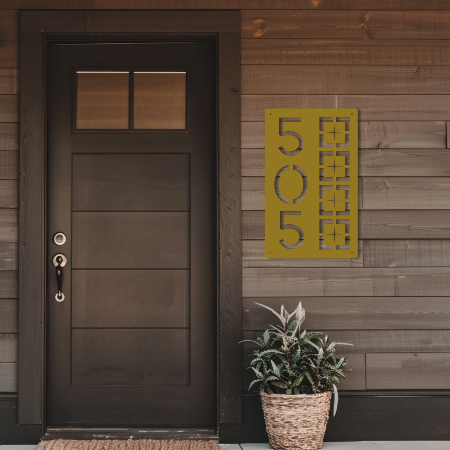 Metal Address Sign, Vertical Starburst Block shown in gold on wooden siding of cozy front porch