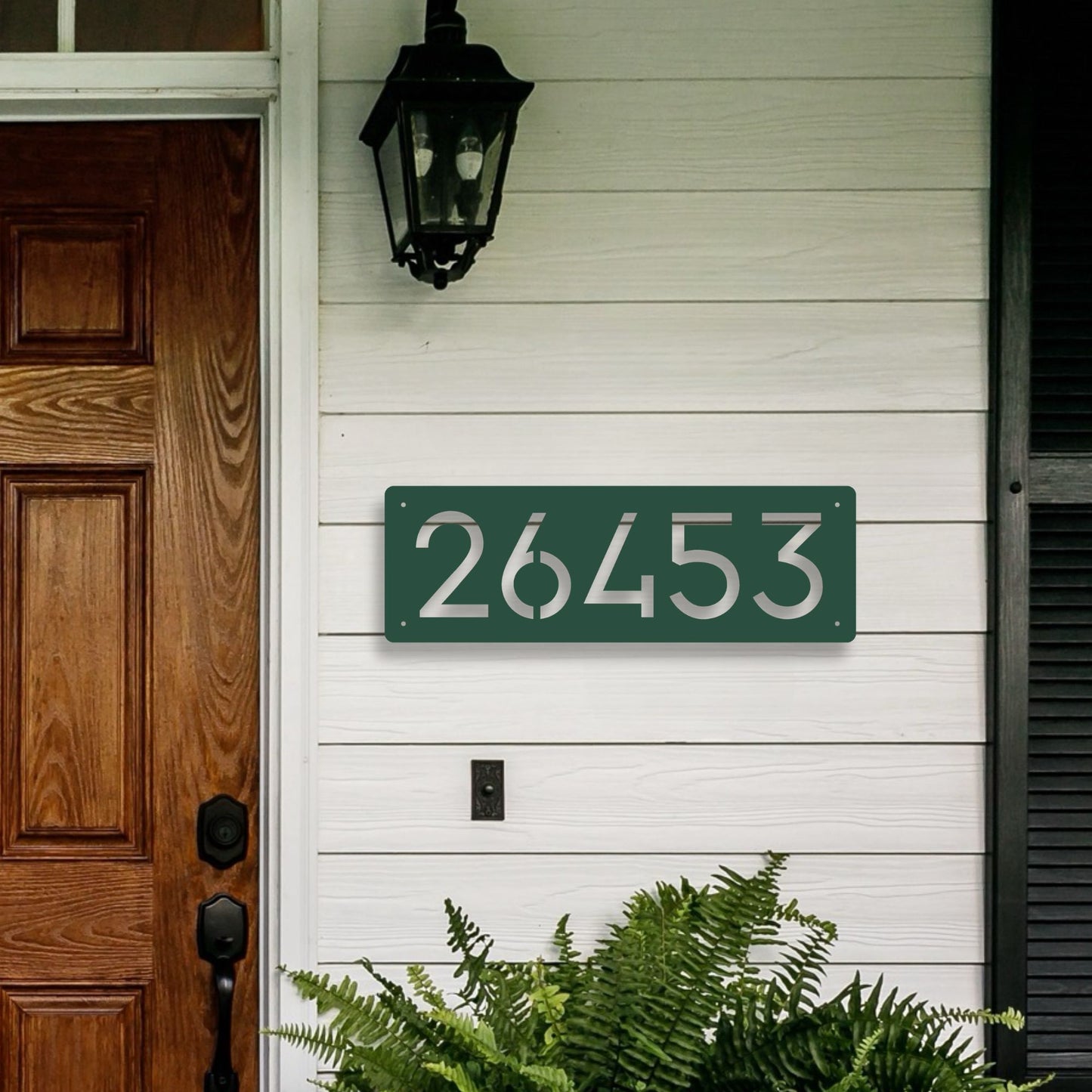 Horizontal Number Address Sign, Closed Style shown in green on front porch with warm wood door and white siding