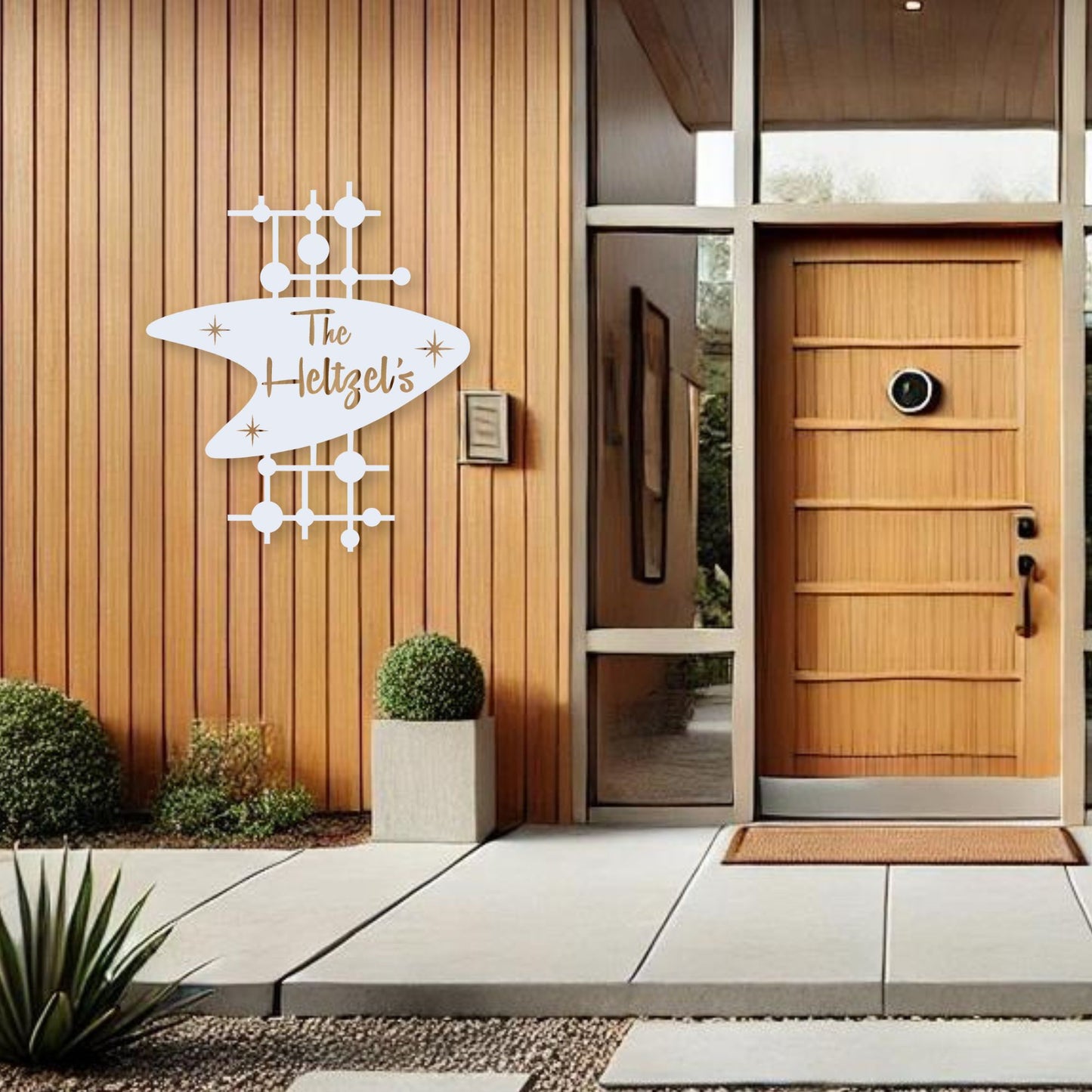 Modern house entrance with wooden door and decorative sign.