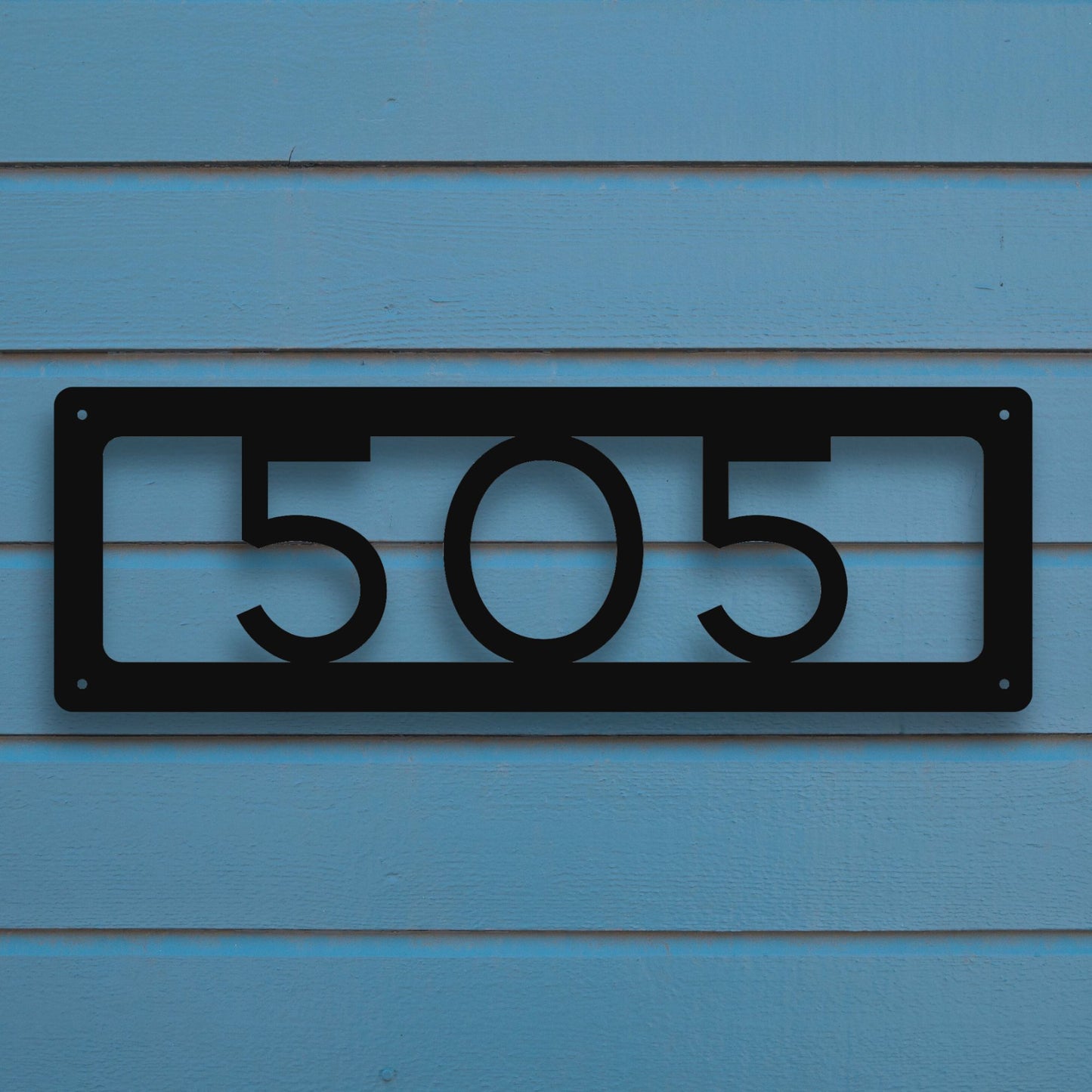 Horizontal Number Address Sign, Open Styles shown in black against blue siding of house