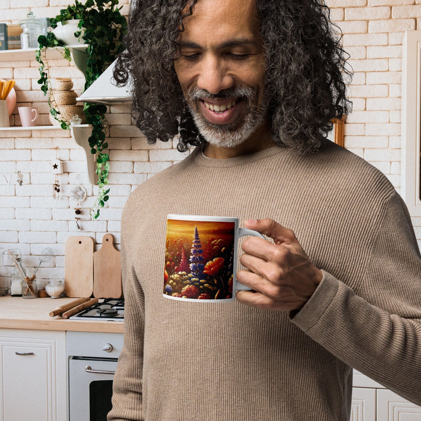 Man holding a mug with a colorful design in a kitchen