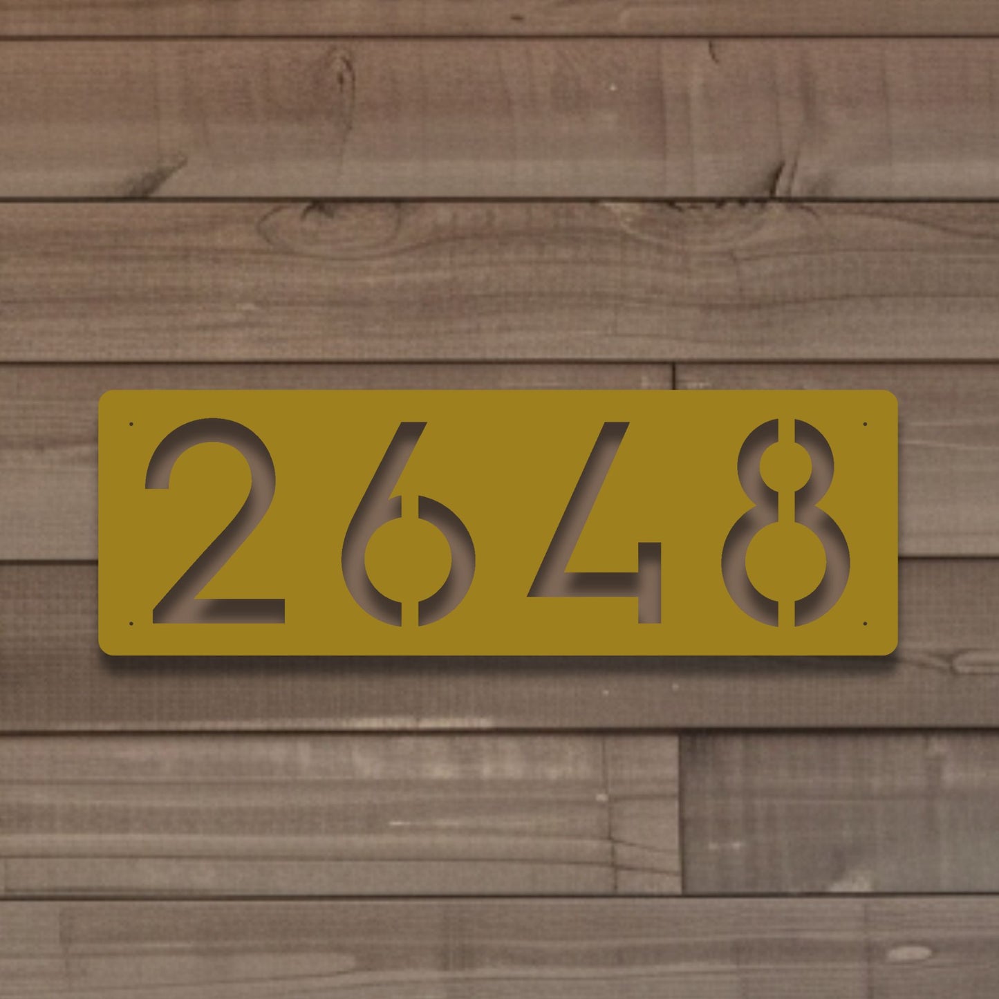 Horizontal Number Address Sign, Closed Style shown in gold against worn wood siding on home