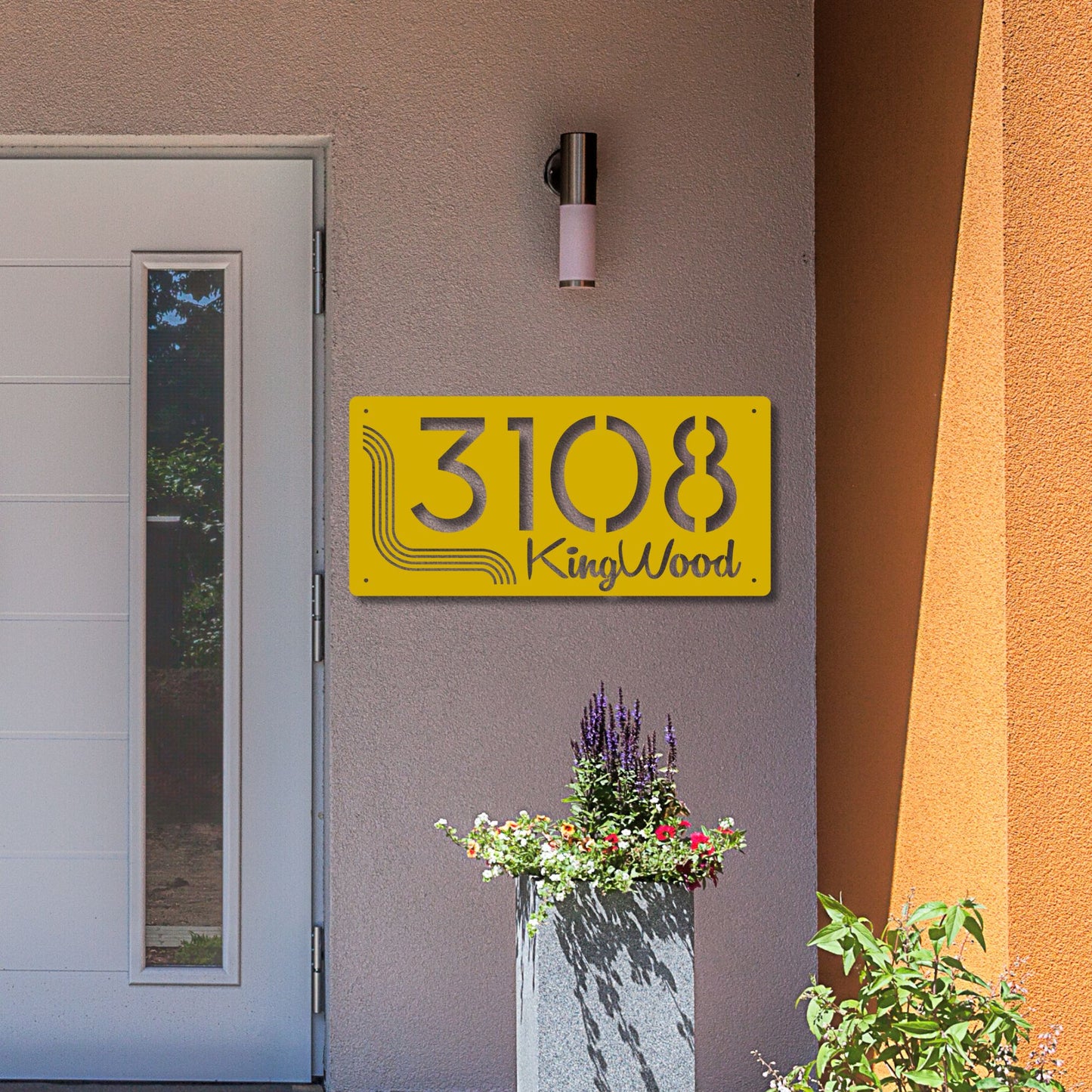 Yellow address sign with '3108 KingWood' on a building exterior.