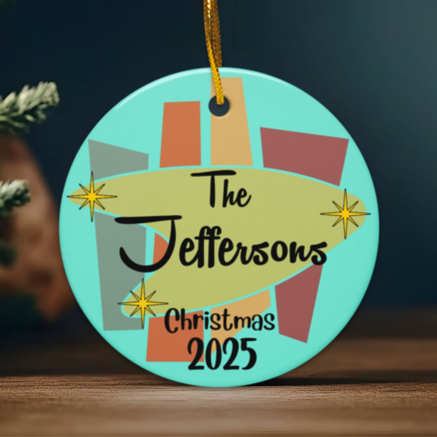 Decorative Christmas ornament with 'The Jeffersons Christmas 2025' text on a teal background.