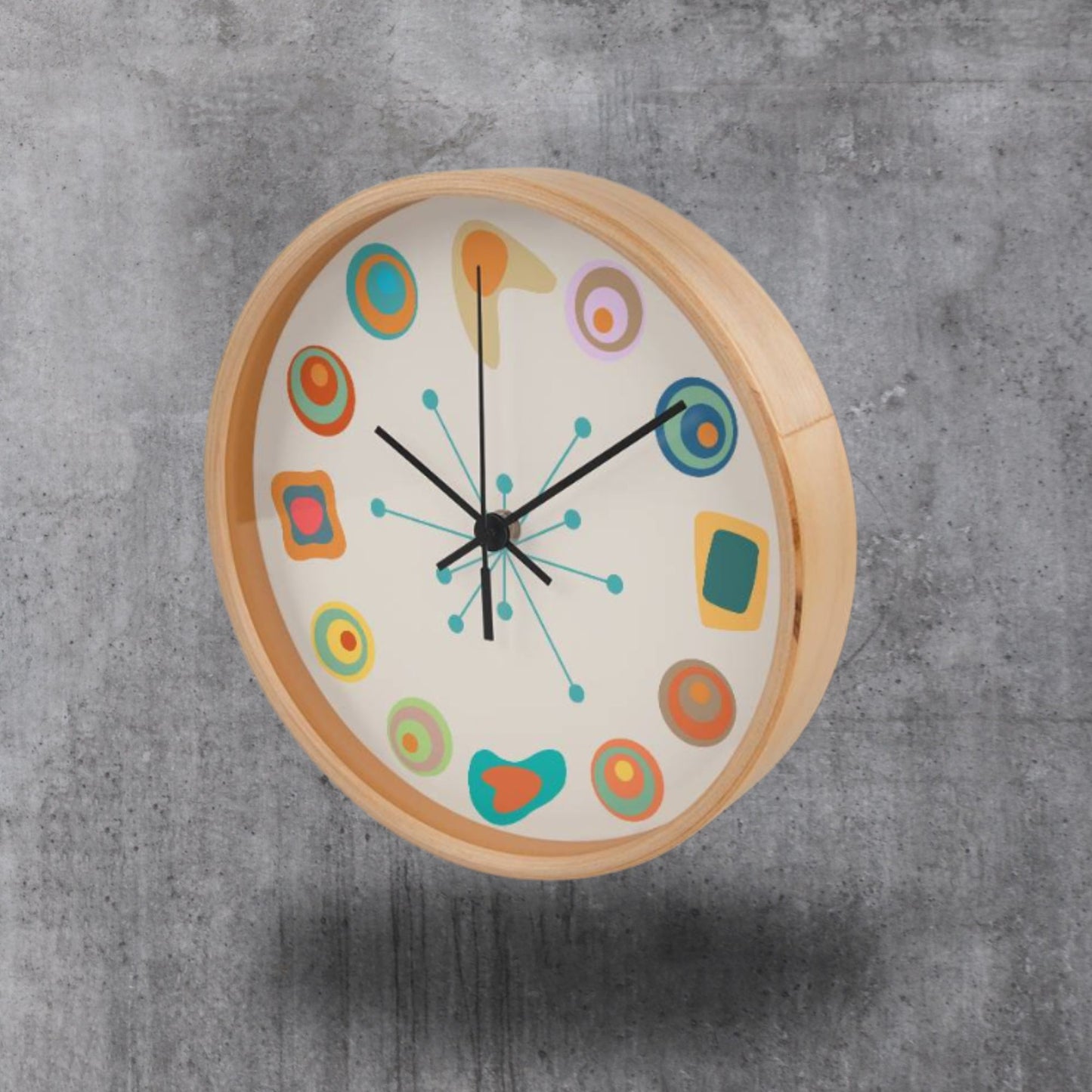 Colorful wall clock with wooden frame on a gray concrete background