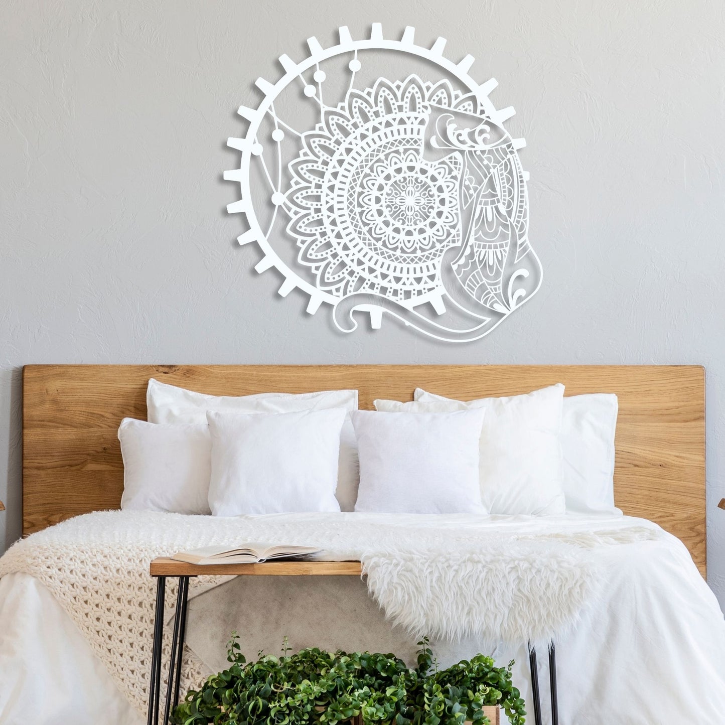 Decorative wall art above a bed with white bedding and wooden headboard.