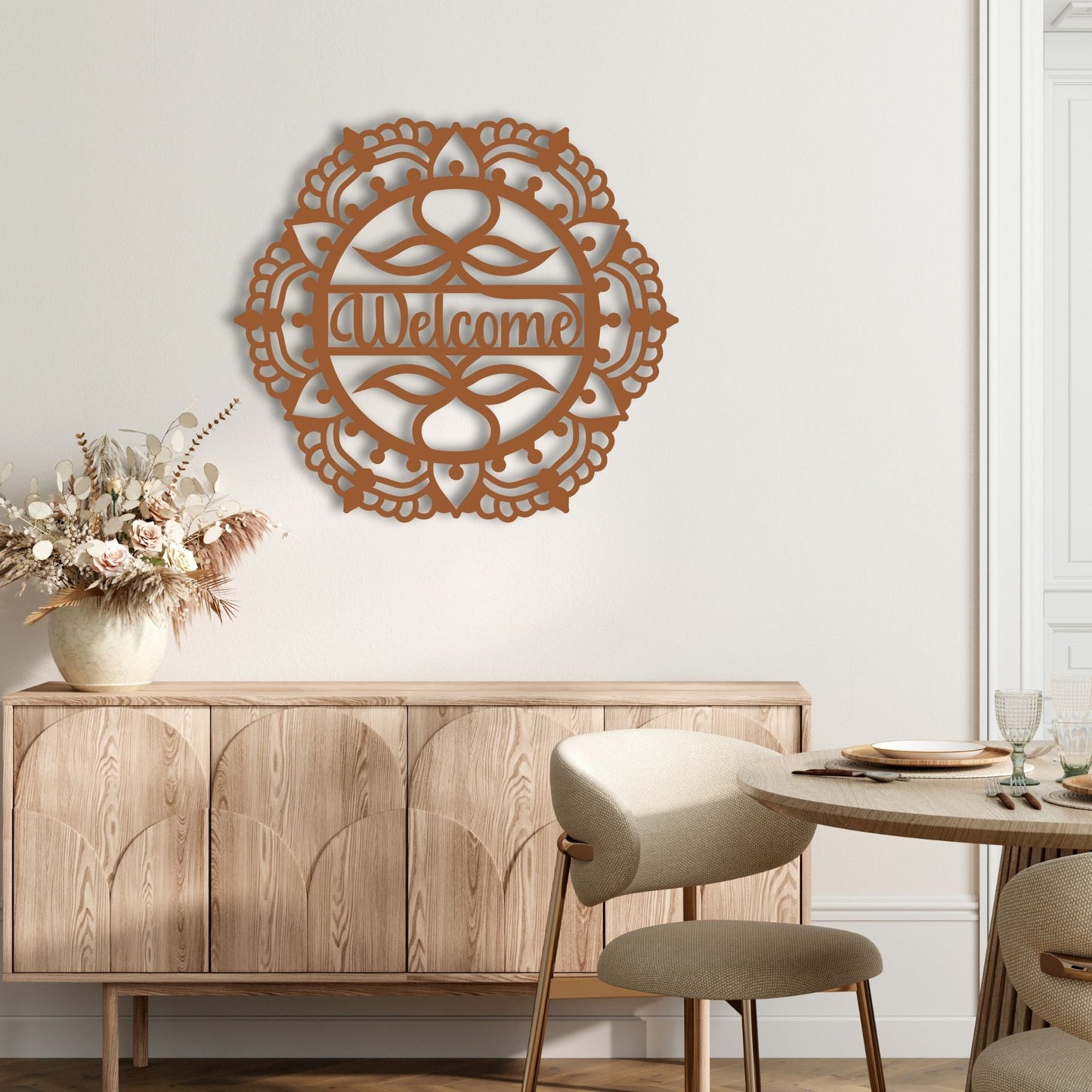 Decorative wall art with 'Welcome' on a wall above a wooden sideboard in a dining room.