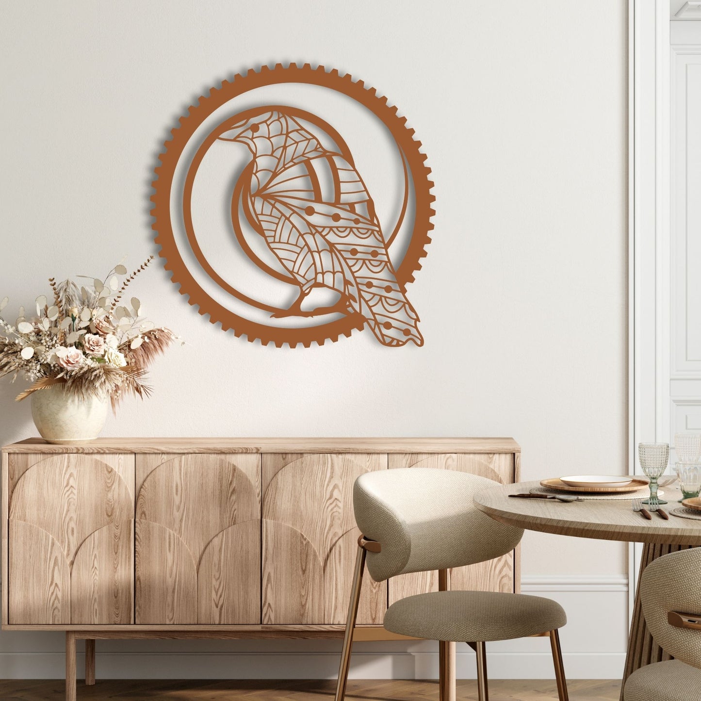 Decorative wall art with a ship design on a wooden wall above a wooden cabinet and table.