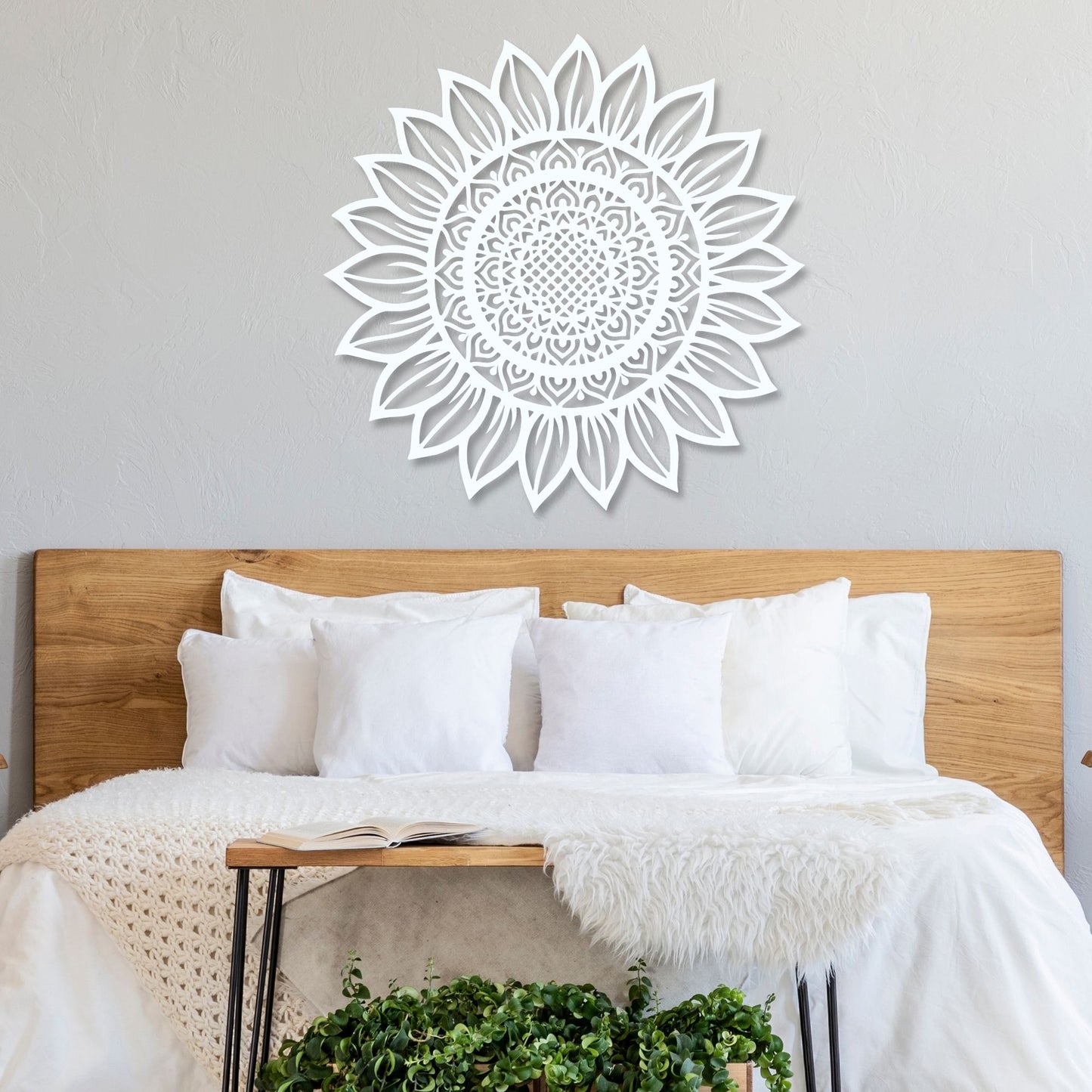 Decorative sunflower wall art above a bed with white bedding and wooden headboard.