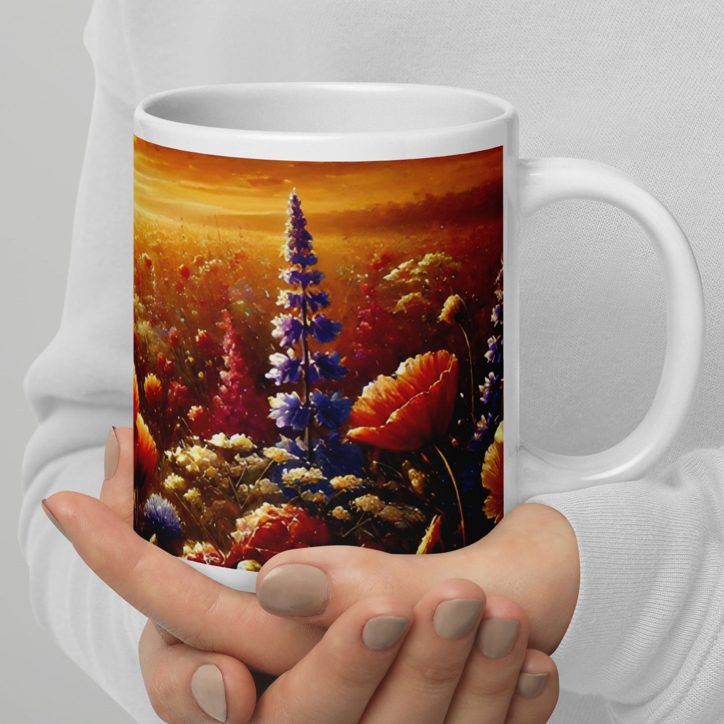 Person holding a mug with a floral painting design on a gray background