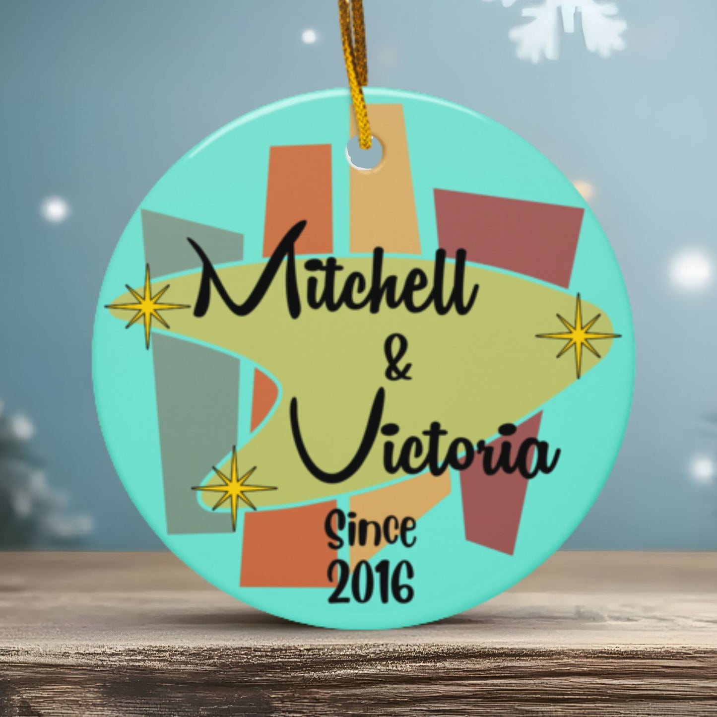Decorative ornament with 'Mitchell & Victoria Since 2016' text on a blue background