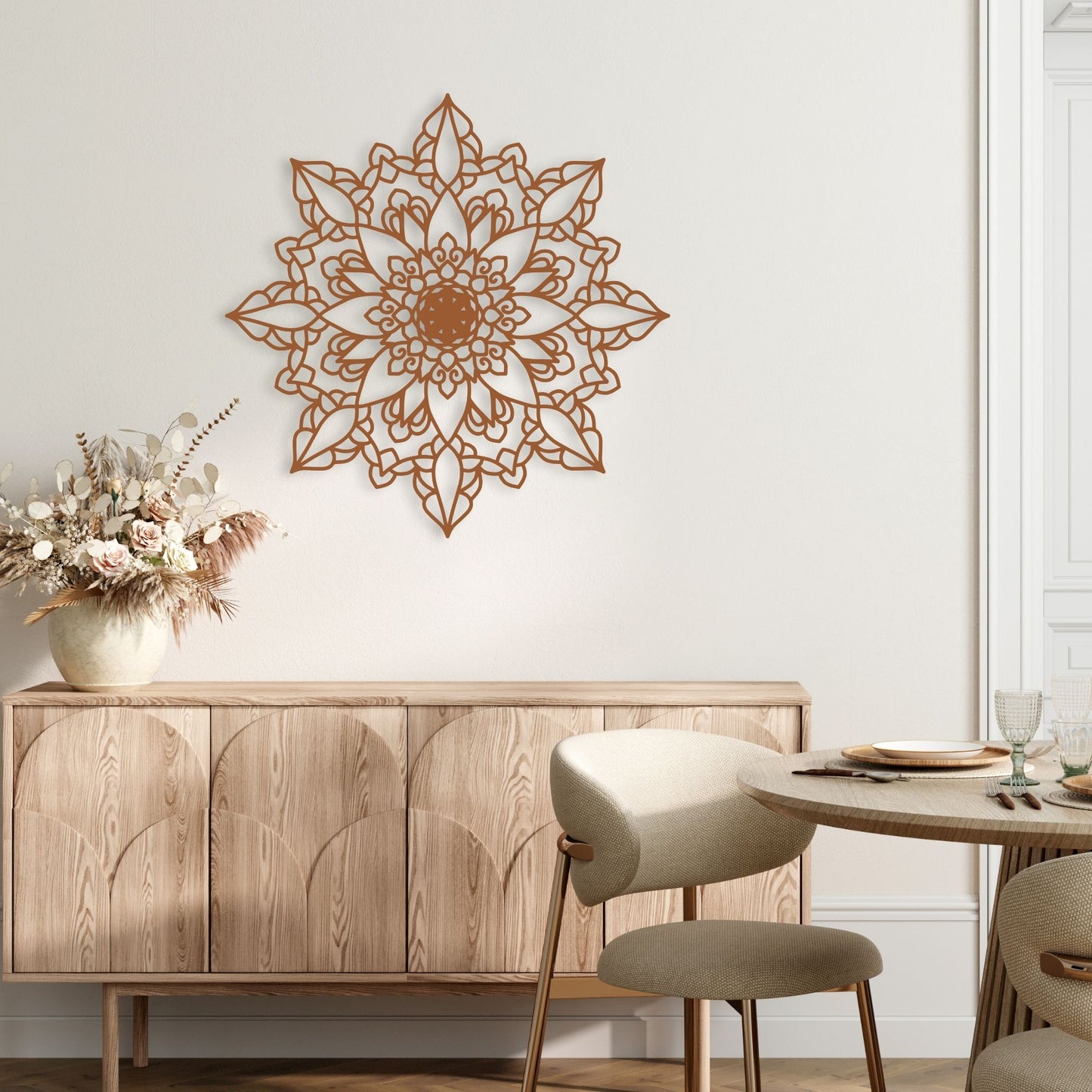 Decorative wall mandala above a wooden cabinet in a room with a table and chairs.