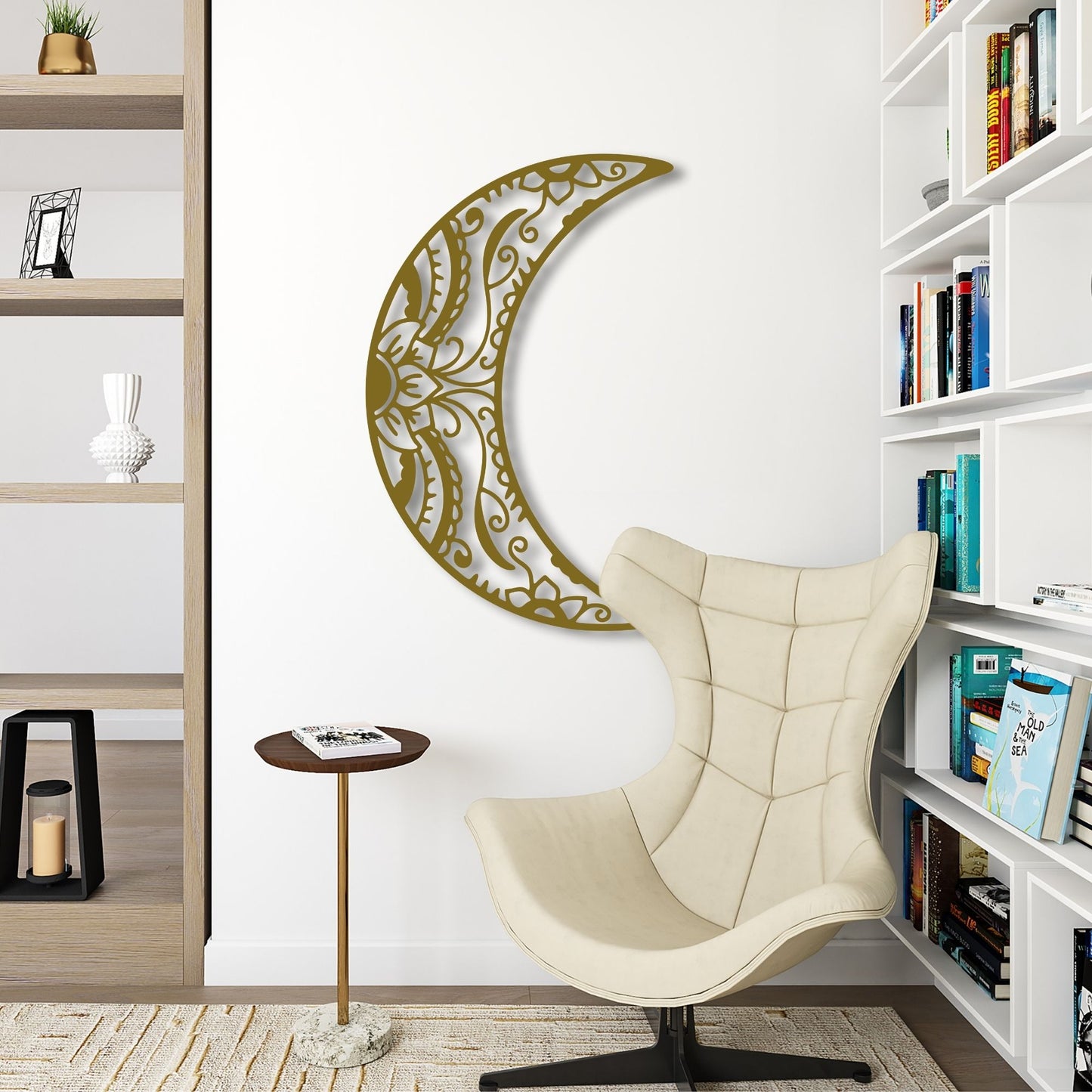 Decorative wall art in the shape of a crescent moon with intricate patterns, placed above a beige armchair in a room with bookshelves.