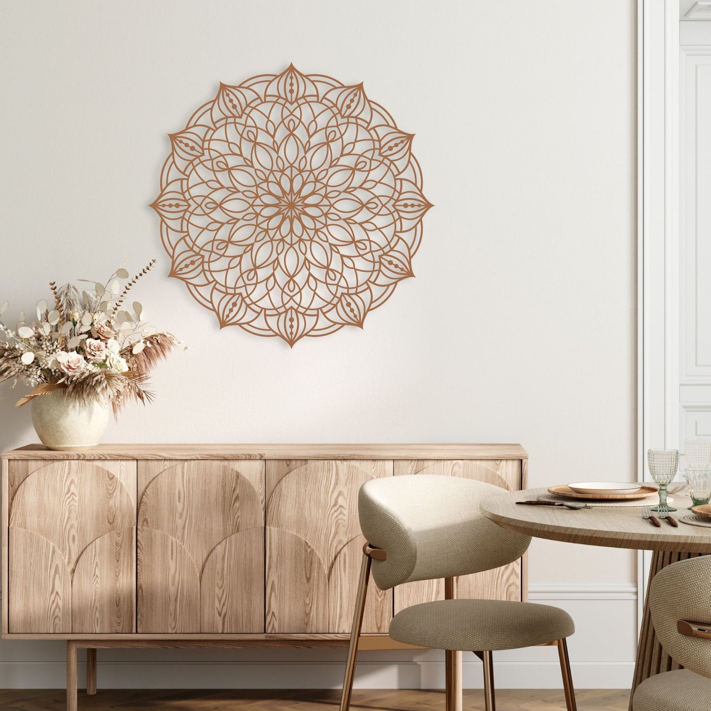 Decorative wall mandala above a wooden sideboard with a table and chairs in a room.