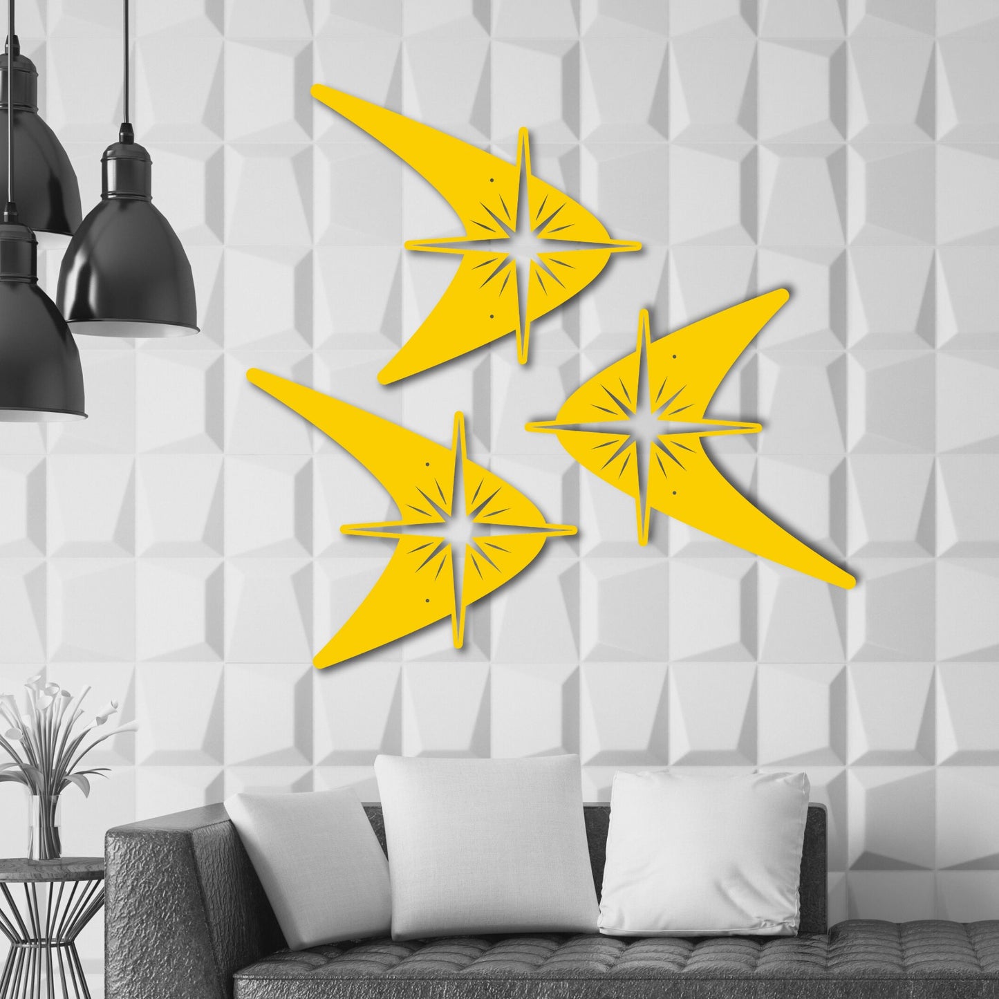 Yellow abstract wall art on a textured white wall with a sofa and black pendant lights in the foreground.