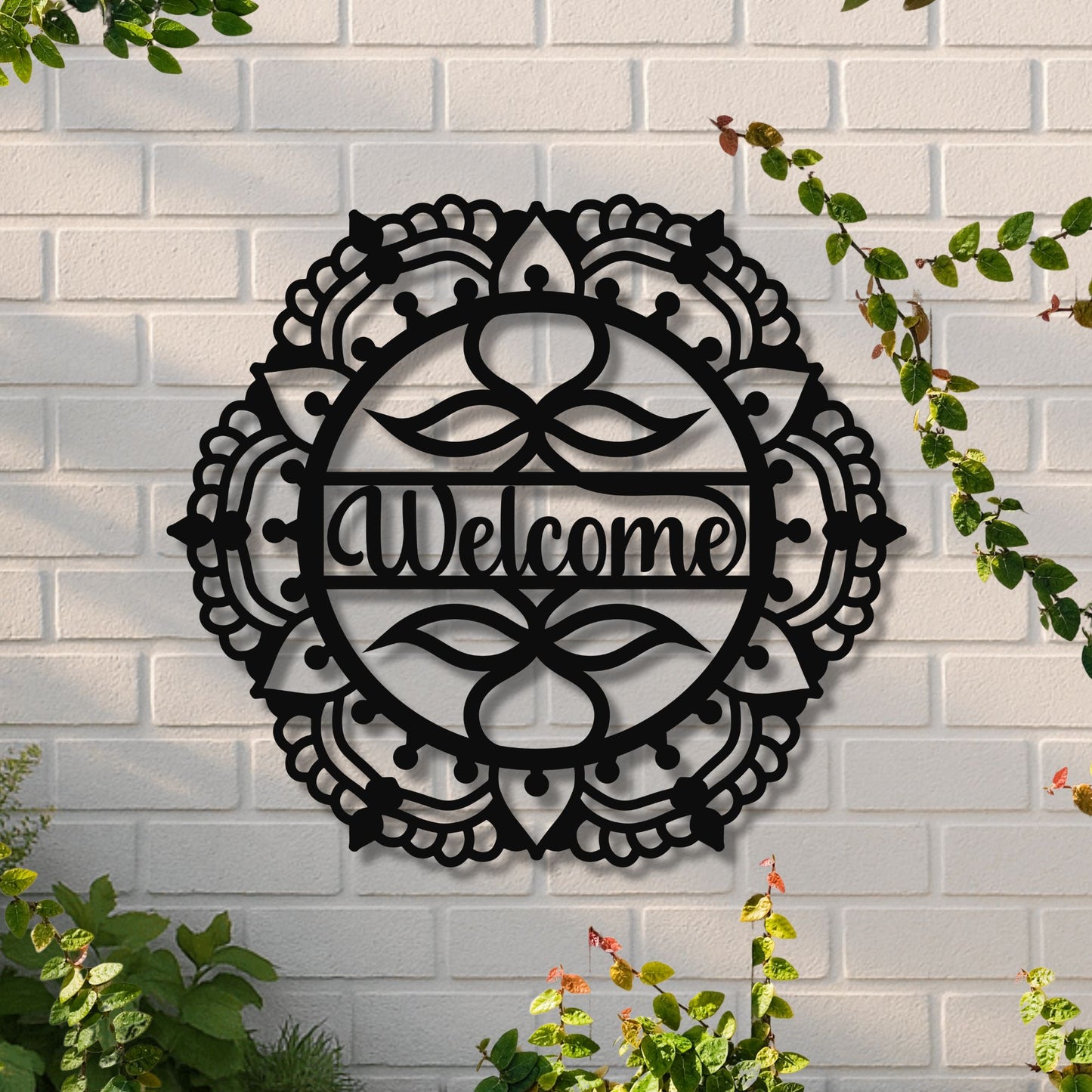 Decorative metal wall art with 'Welcome' text on a white brick wall.