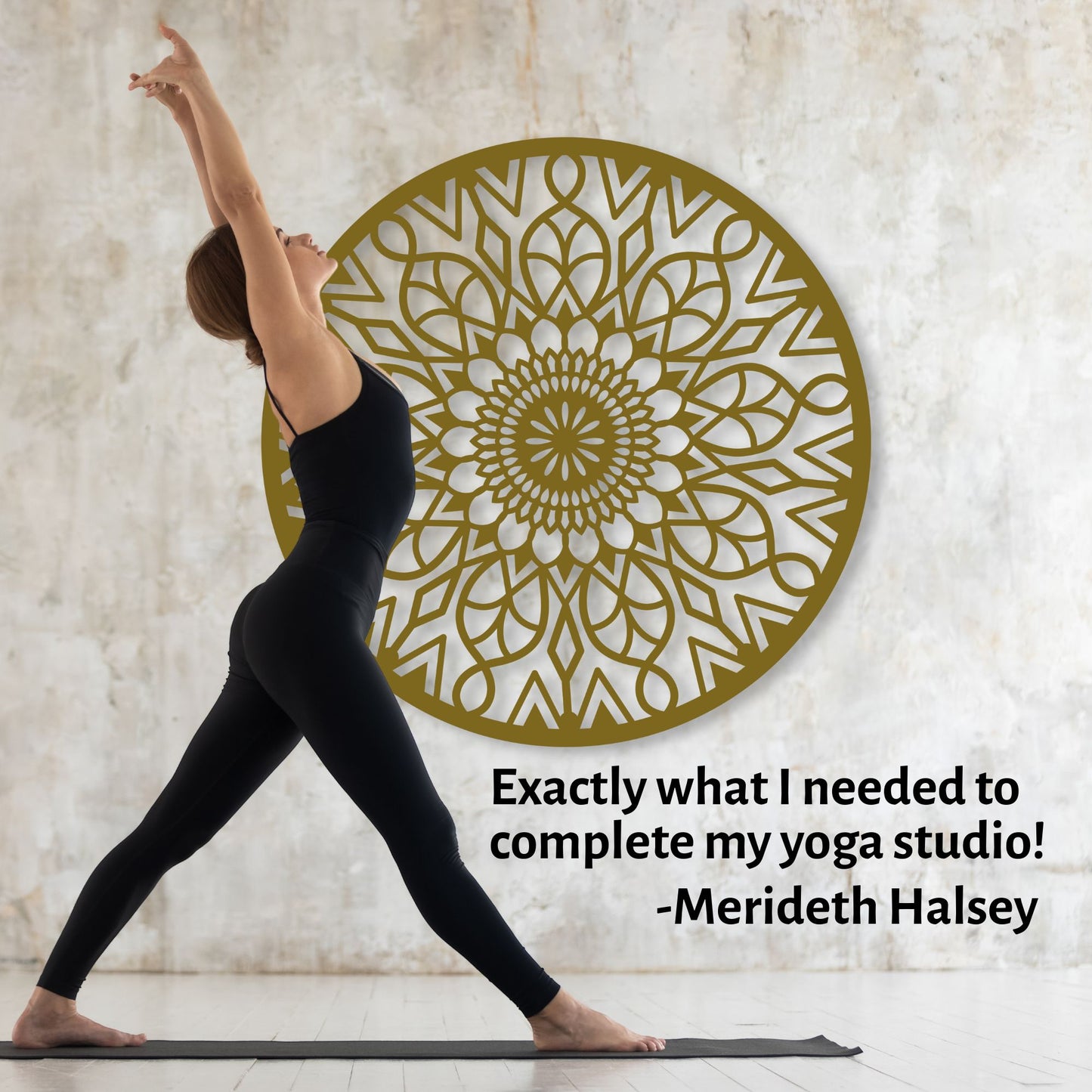Woman in a yoga pose with a decorative wall art piece in the background