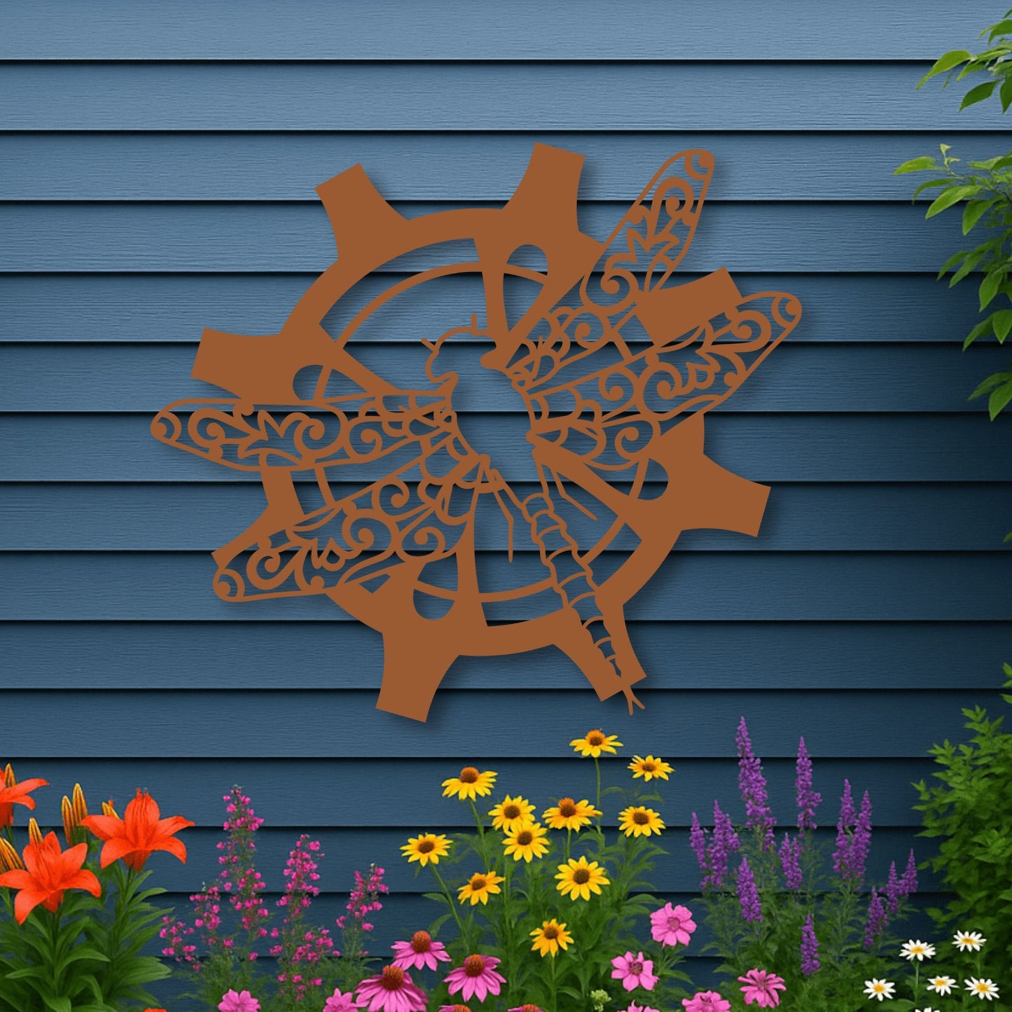 Decorative metal wall art of a deer and antlers on a blue wooden wall with flowers in the foreground.