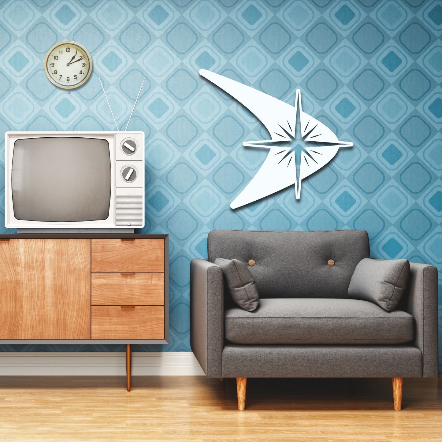 Living room with vintage TV, gray sofa, and decorative wall clock against a blue patterned wall.
