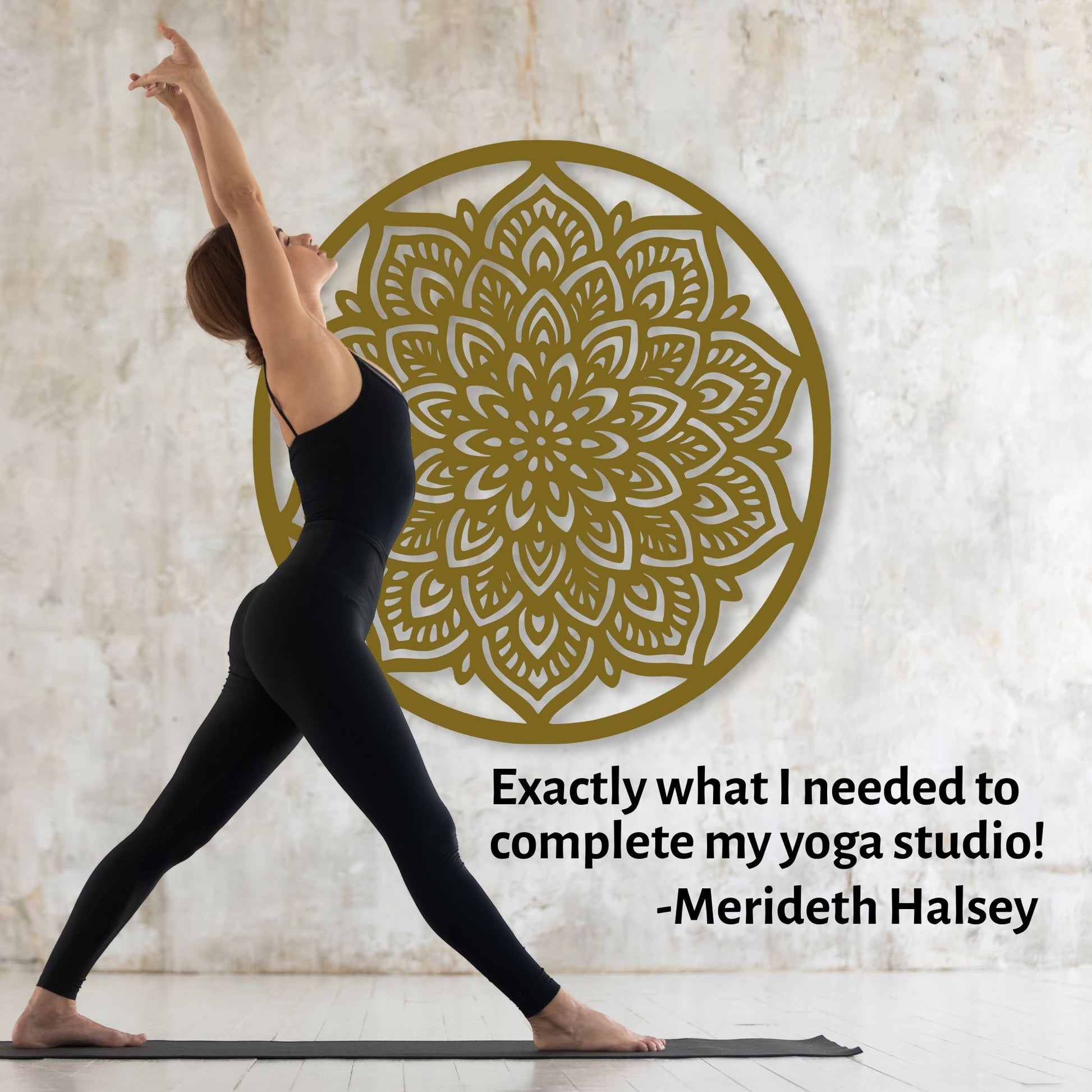 Person in black athletic wear practicing yoga in front of a decorative wall piece with a gold mandala design.