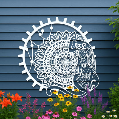 Decorative wall art of a fish and mandala design on a blue wooden wall with flowers in the foreground.