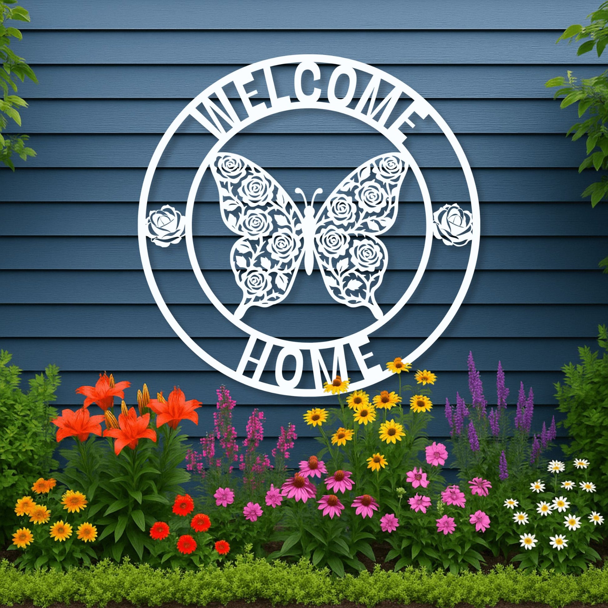 Decorative metal sign with butterfly and floral design on a blue wall with garden flowers below.
