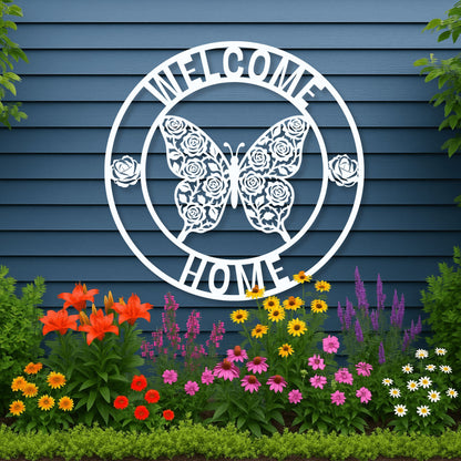 Decorative metal sign with butterfly and floral design on a blue wall with garden flowers below.