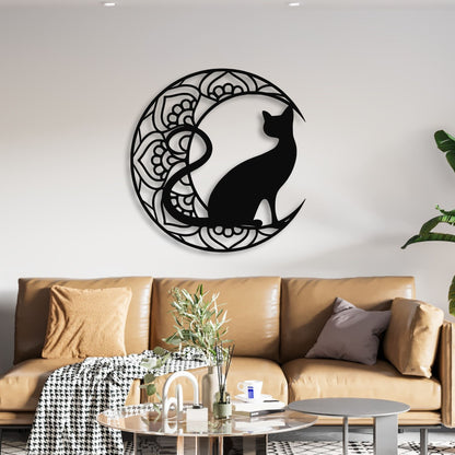 Decorative wall art of a black cat silhouette in a circular design on a white wall above a brown sofa.