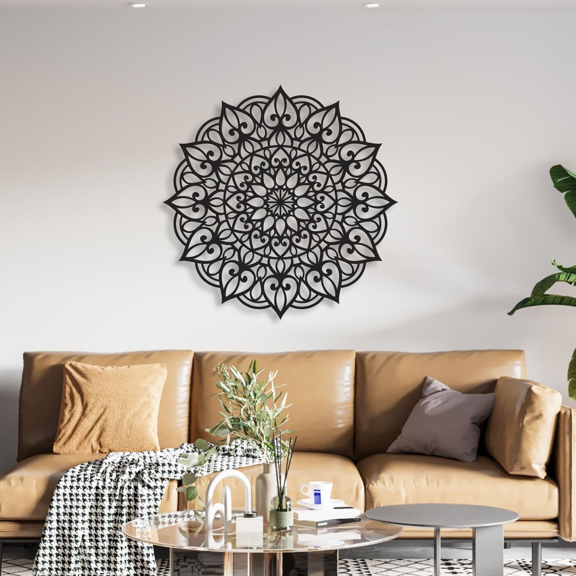 Decorative black mandala wall art above a brown sofa in a living room.