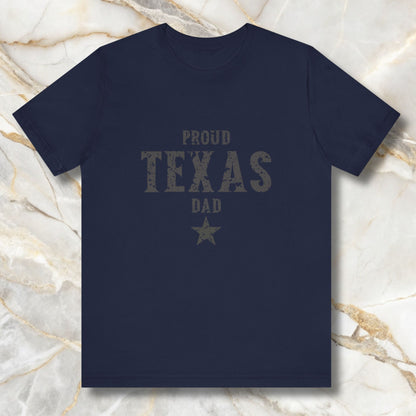 Navy blue t-shirt with 'Proud Texas Dad' text on a marble background