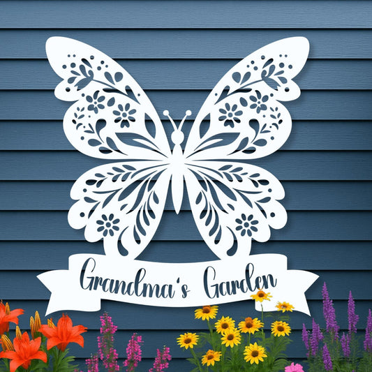 Decorative metal butterfly with 'Grandma's Garden' text in front of a blue wooden wall with flowers below.