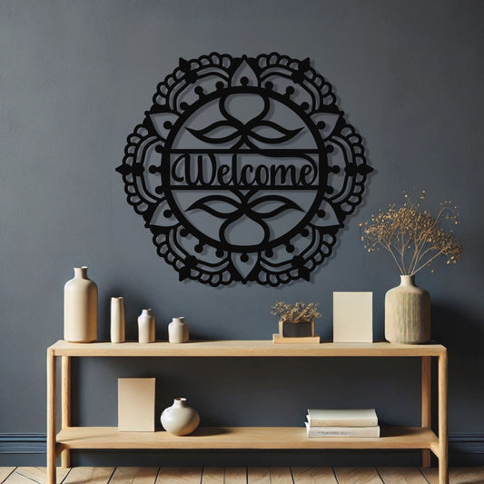Decorative wall art with 'Welcome' on a dark gray wall above a wooden console table.